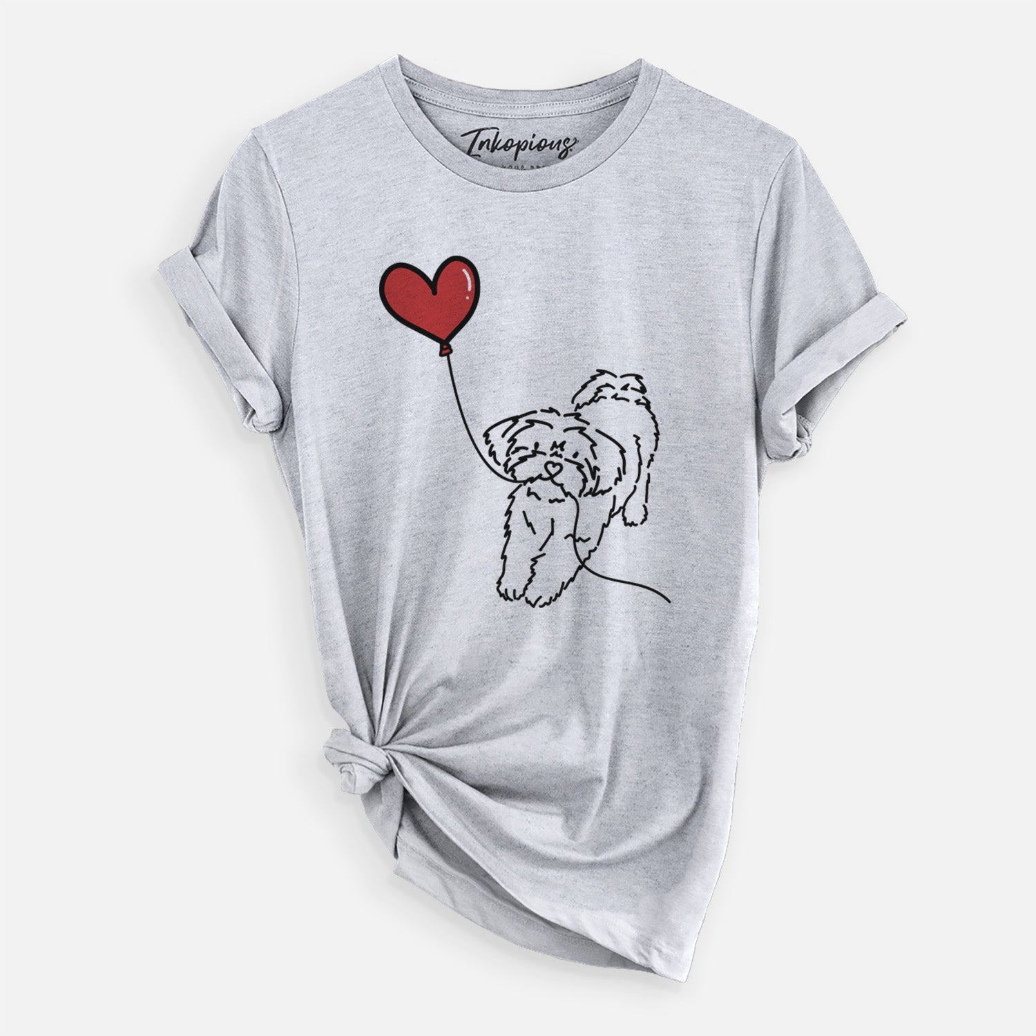 Minimalist line drawing of a Shorkie Heart String- Unisex Crewneck holding a heart balloon on a Grey Unisex crewneck, worn by a woman