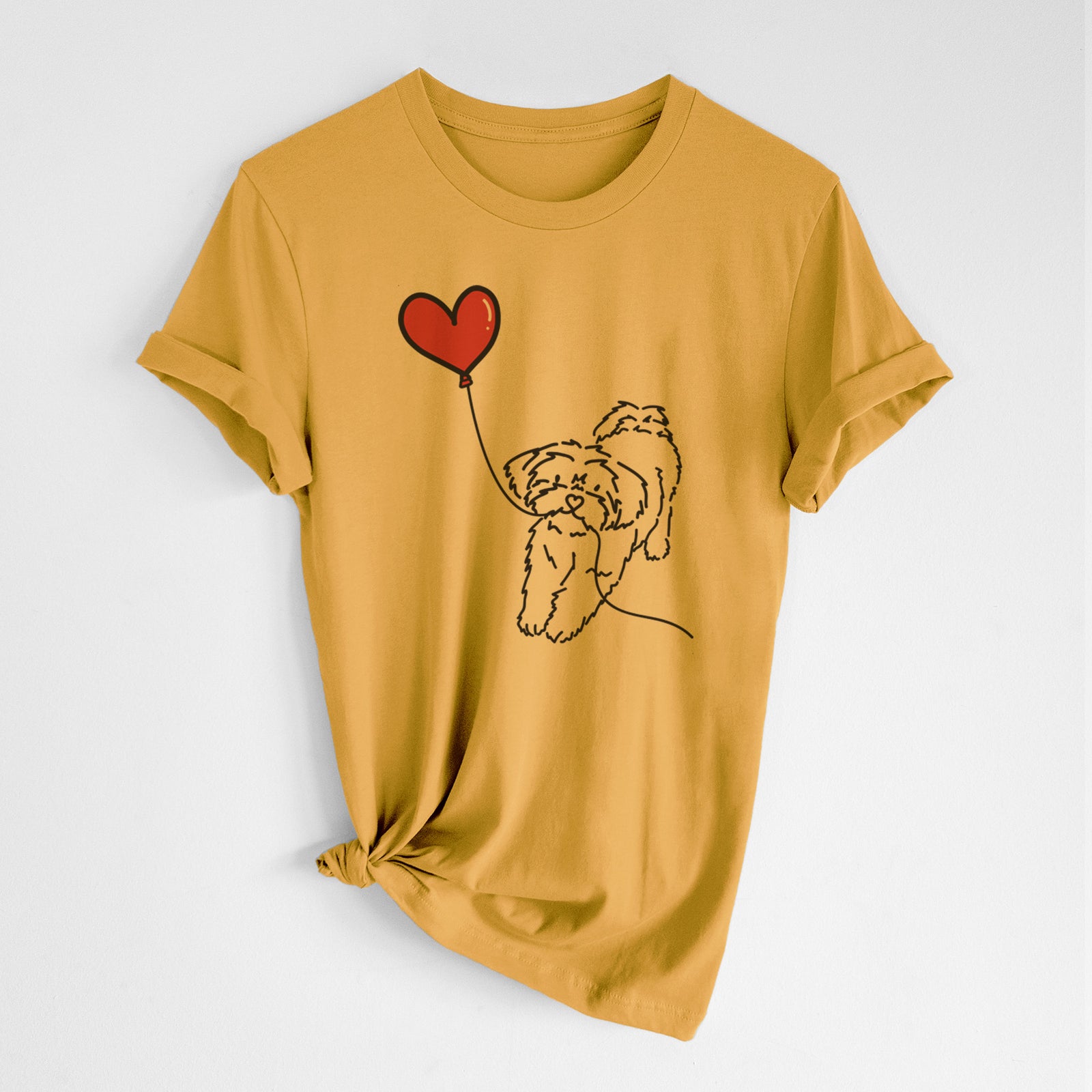 Minimalist line drawing of a Shorkie Heart String- Unisex Crewneck holding a heart balloon on a Mustard Unisex crewneck, worn by a woman