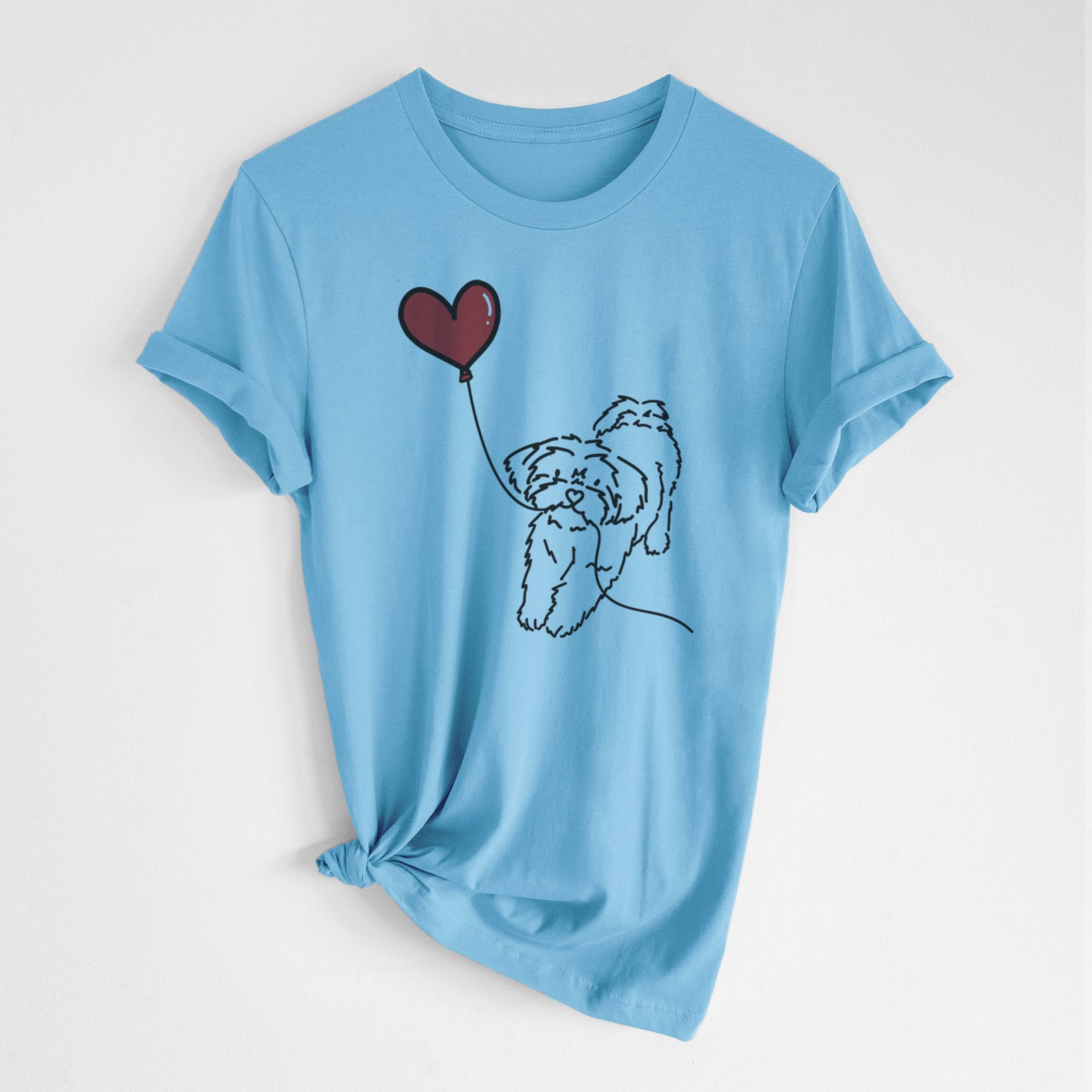 Minimalist line drawing of a Shorkie Heart String- Unisex Crewneck holding a heart balloon on an Ocean Blue Unisex crewneck, worn by a woman
