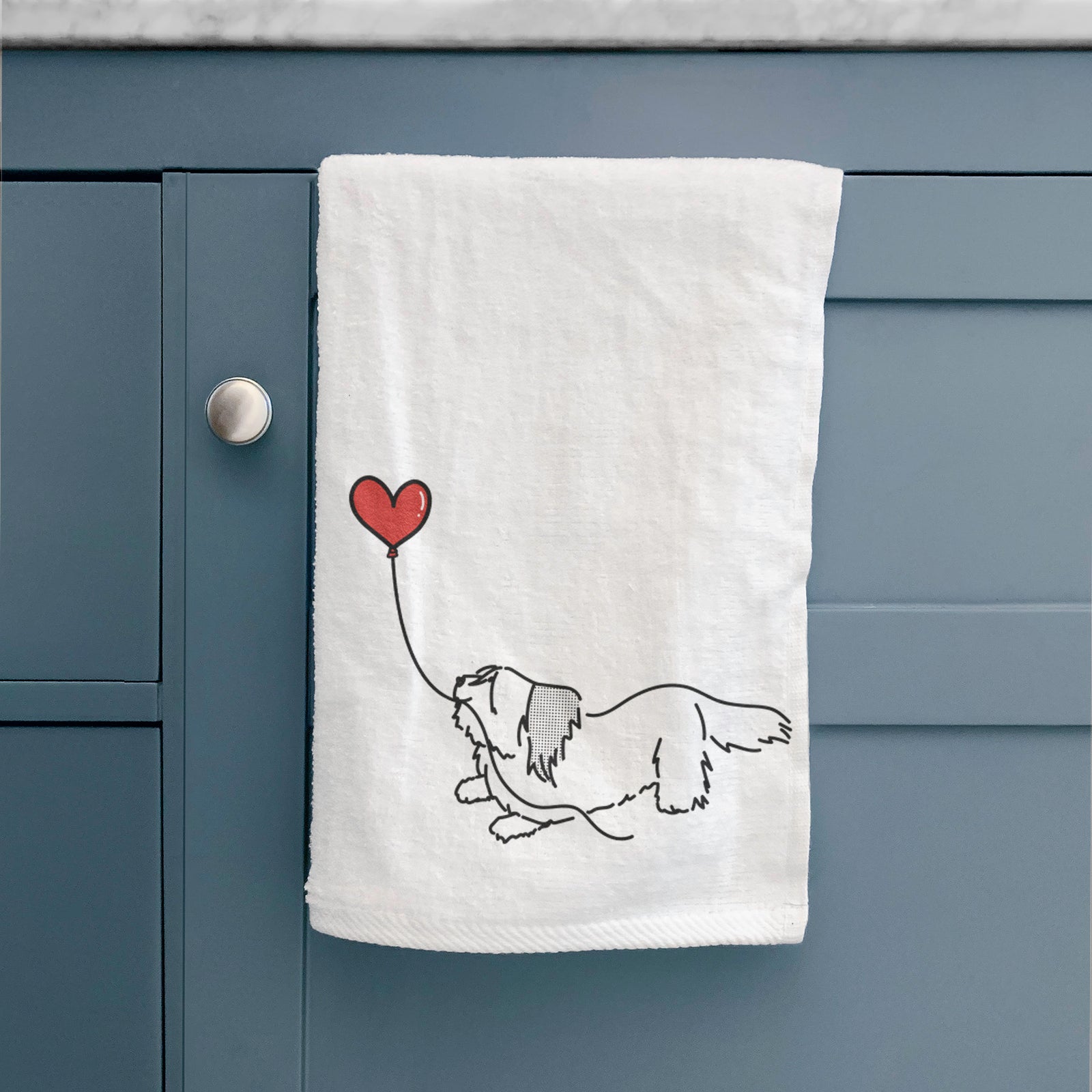 Minimalist line drawing of a Skye Terrier Heart String holding a heart balloon on a decorative hand towel