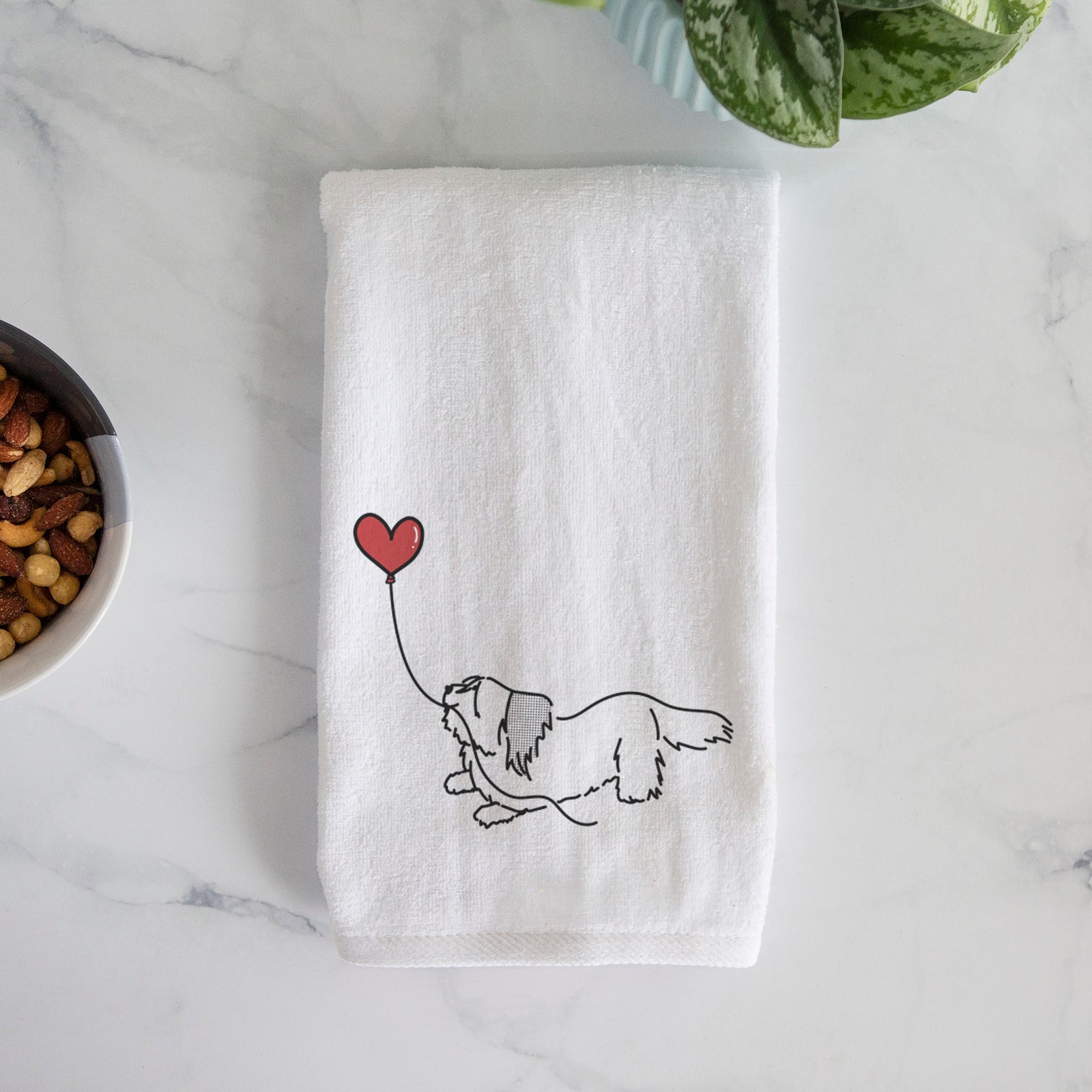 Minimalist line drawing of a Skye Terrier Heart String holding a heart balloon on a decorative hand towel