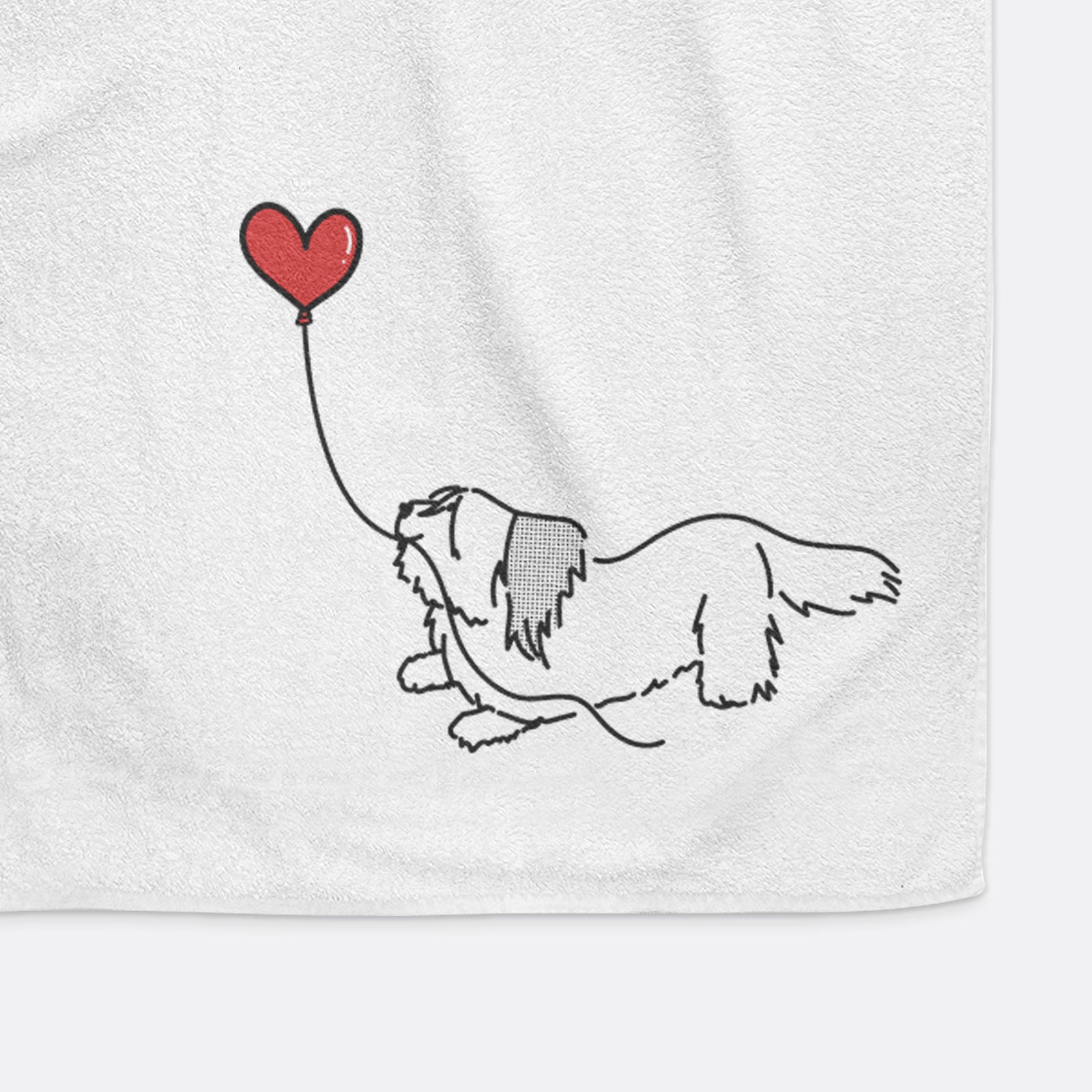 Minimalist line drawing of a Skye Terrier Heart String holding a heart balloon on a decorative hand towel