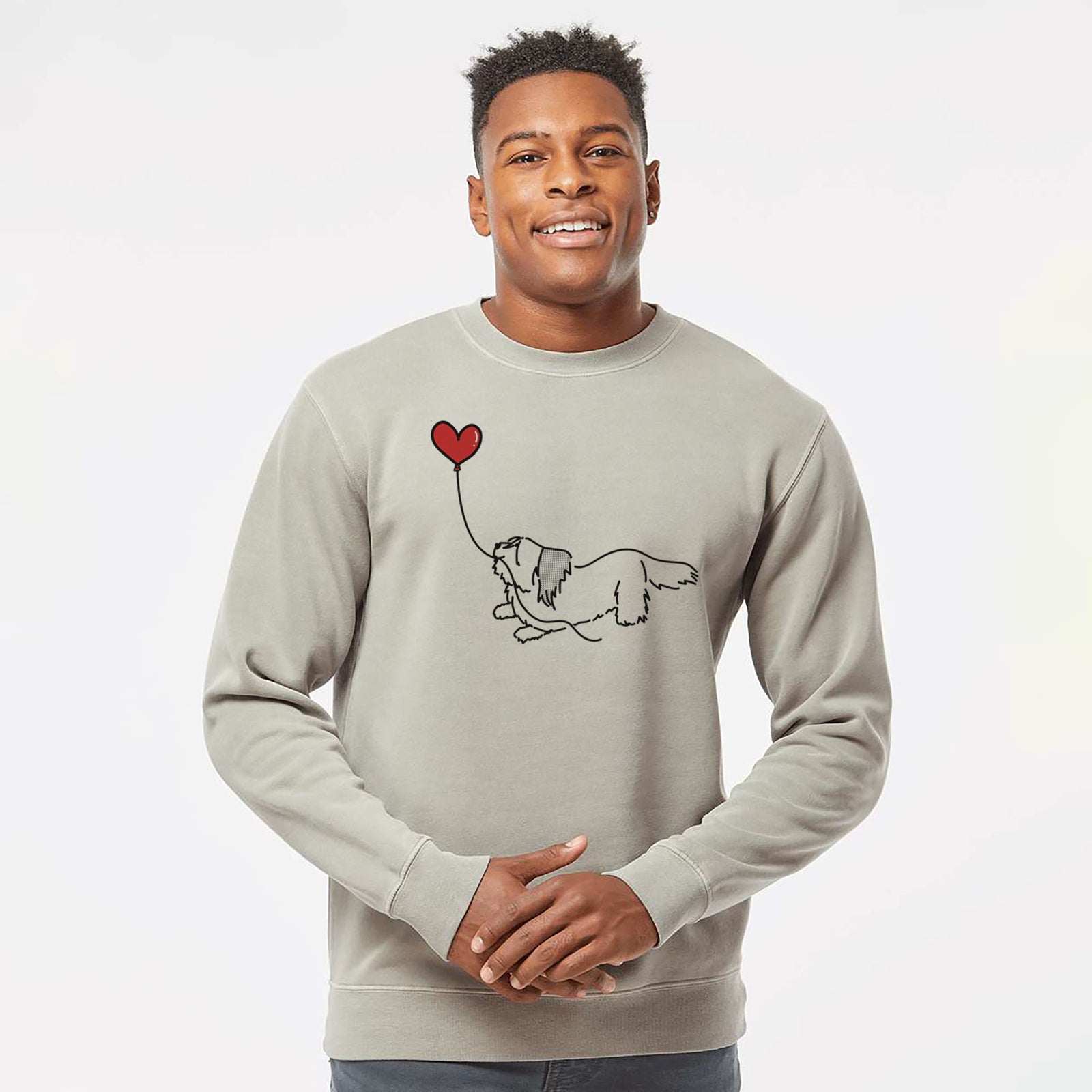 Minimalist line drawing of a Skye Terrier Heart String holding a heart balloon on a Cement Unisex pigment dyed crew sweatshirt