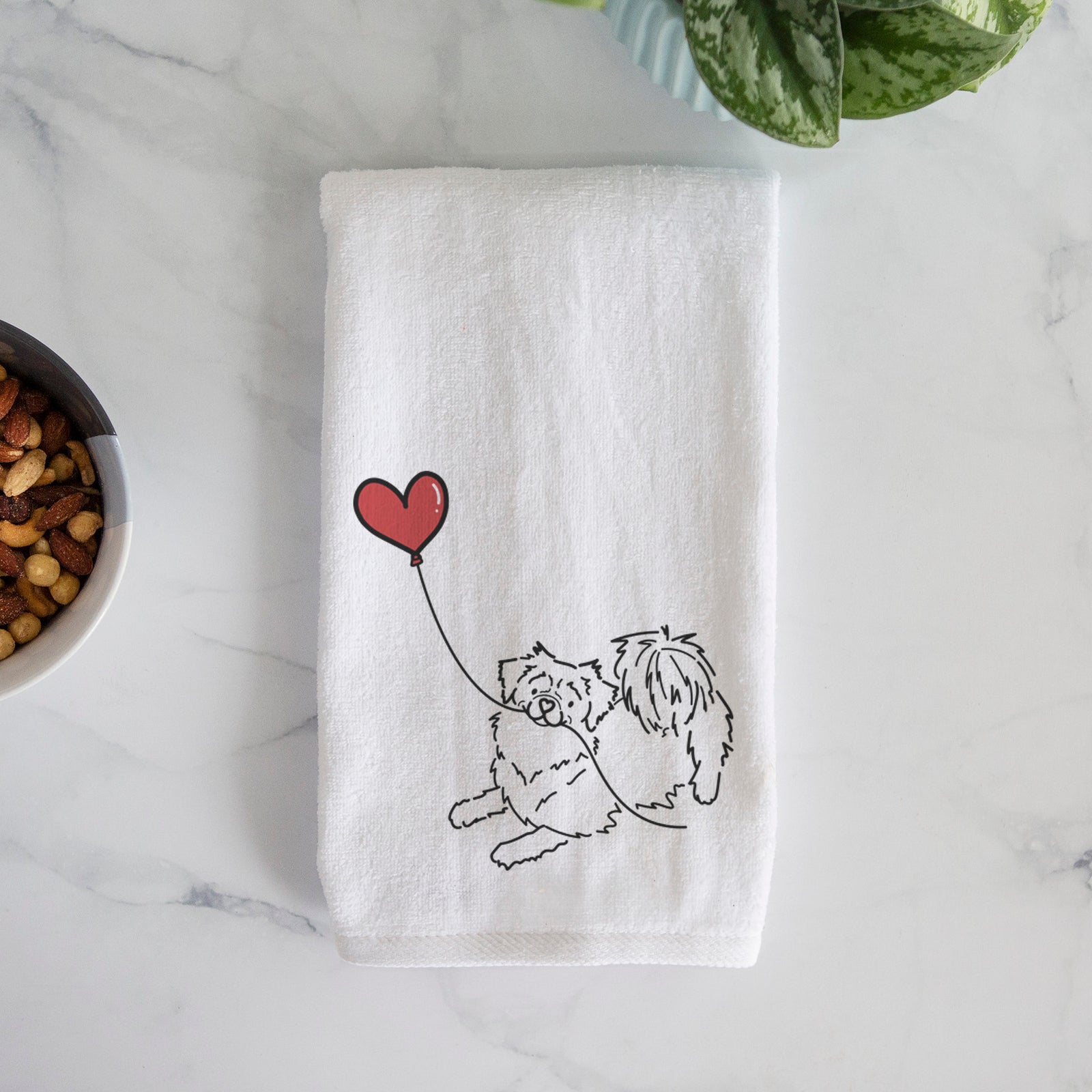 Minimalist line drawing of a Tibetan Spaniel Heart String holding a heart balloon on a decorative hand towel
