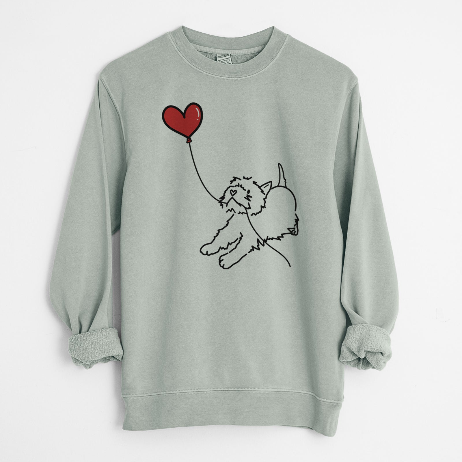 Minimalist line drawing of a West Highland Terrier Heart String holding a heart balloon on a Sage Unisex pigment dyed crew sweatshirt