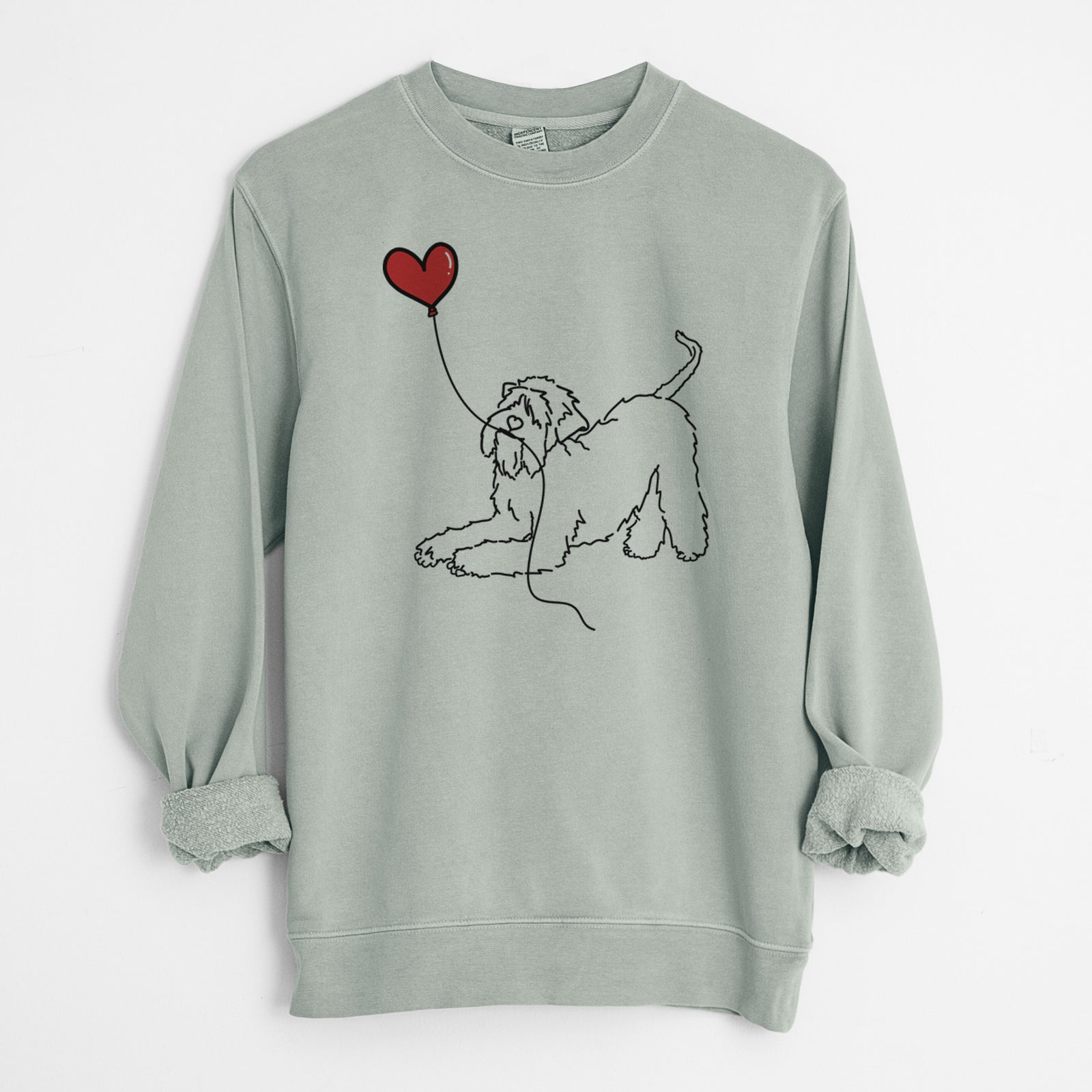 Minimalist line drawing of a Soft-Coated Wheaten Terrier Heart String holding a heart balloon on a Sage Unisex pigment dyed crew sweatshirt