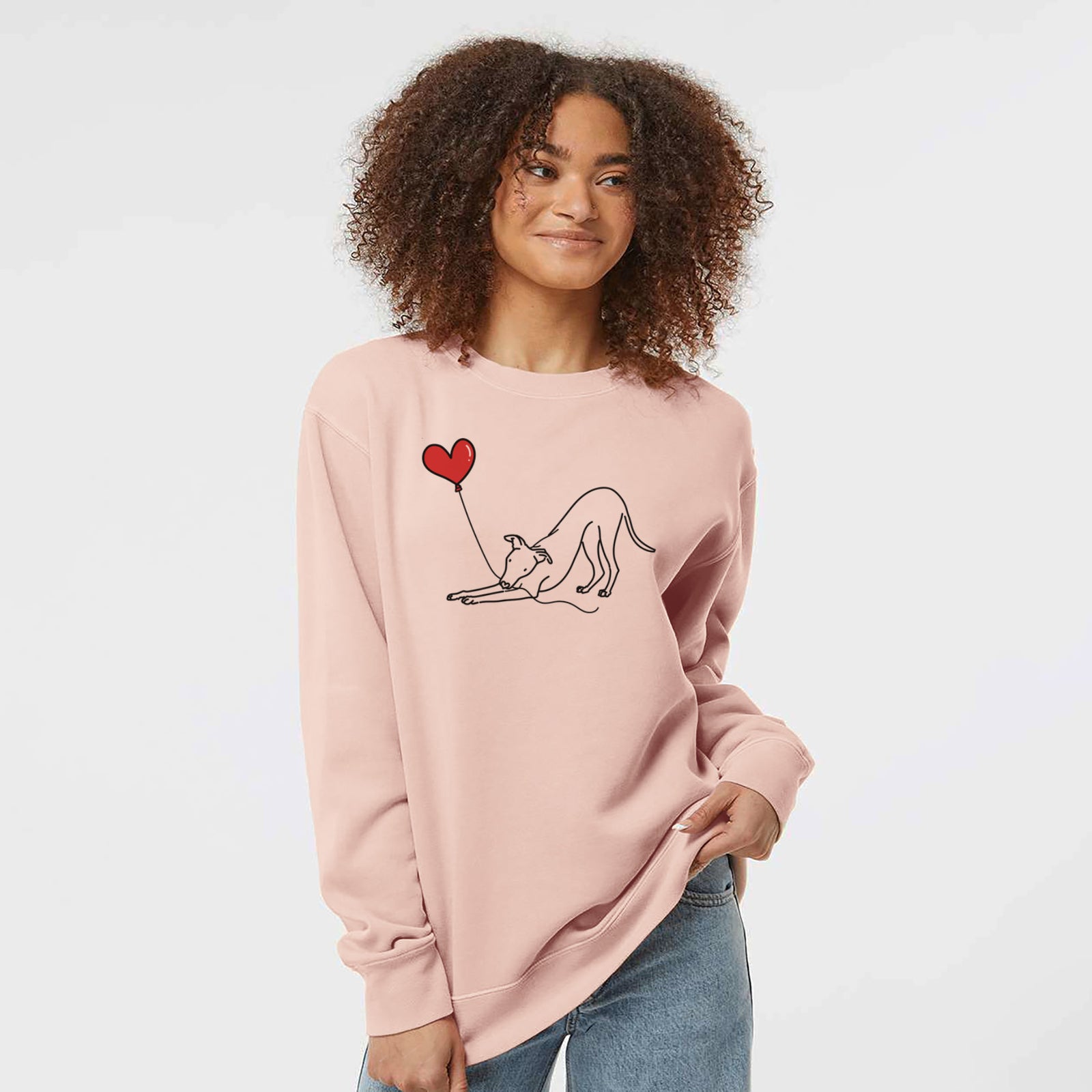 Minimalist line drawing of a Whippet Heart String holding a heart balloon on a Dusty Pink Unisex pigment dyed crew sweatshirt