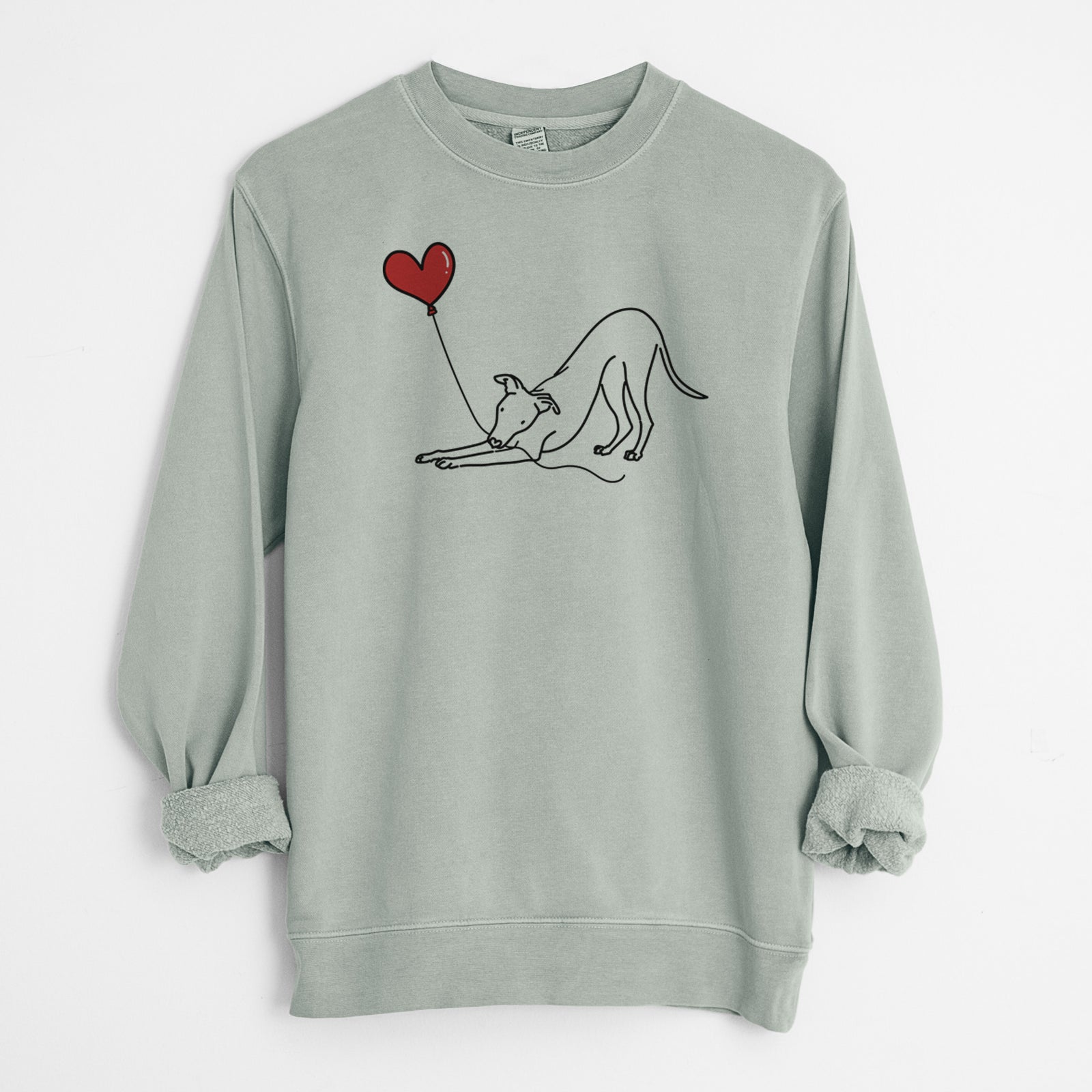Minimalist line drawing of a Whippet Heart String holding a heart balloon on a Sage Unisex pigment dyed crew sweatshirt