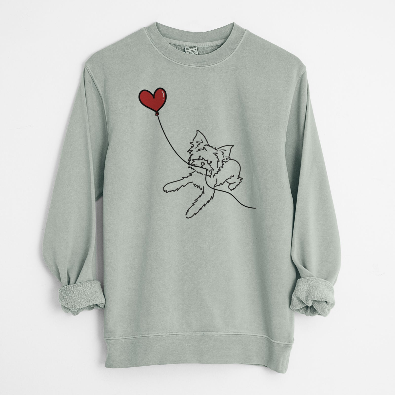 Minimalist line drawing of a Yorkshire Terrier Heart String holding a heart balloon on a Sage Unisex pigment dyed crew sweatshirt