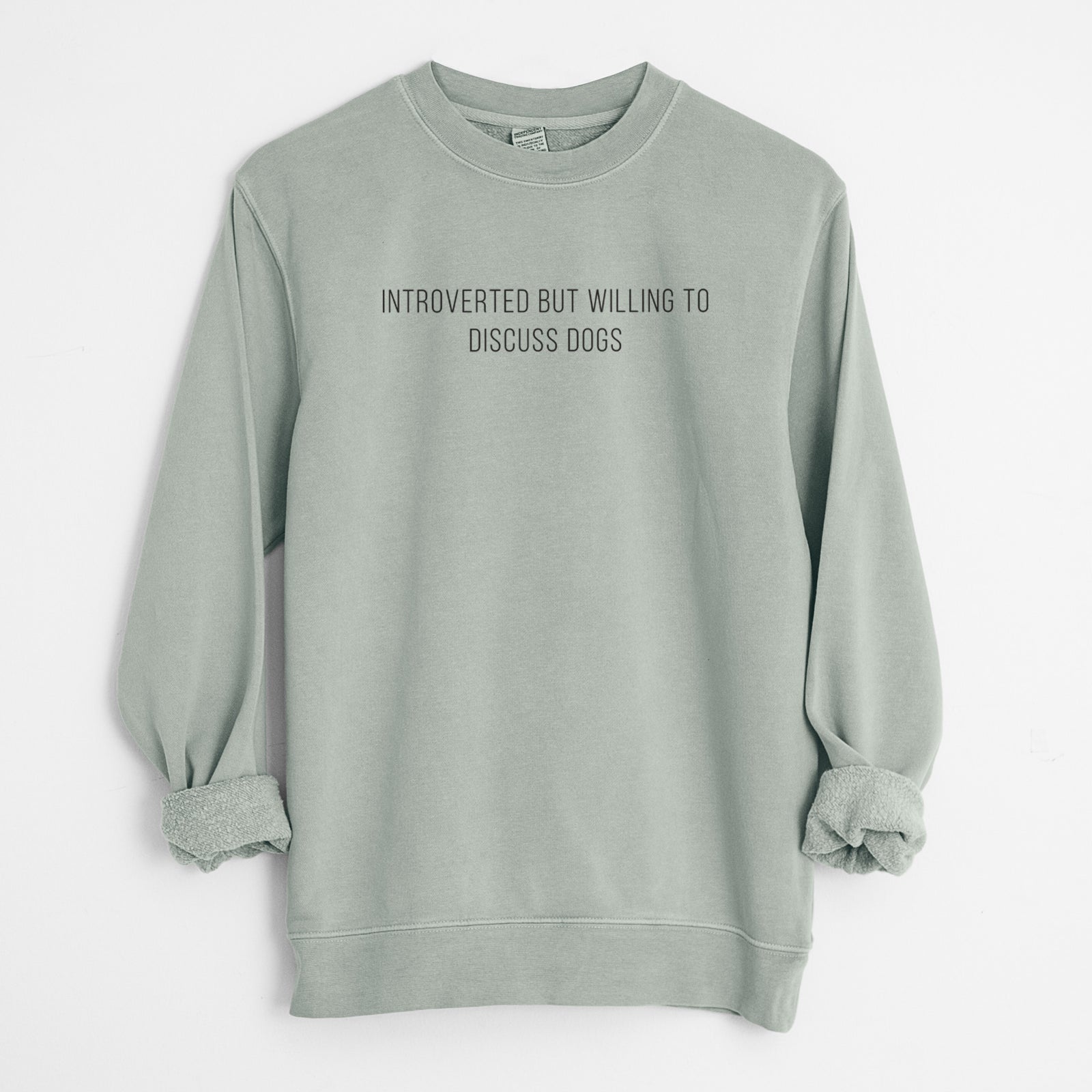 'Introverted but Willing to Discuss Dogs' design on a Sage Unisex pigment dyed crew sweatshirt
