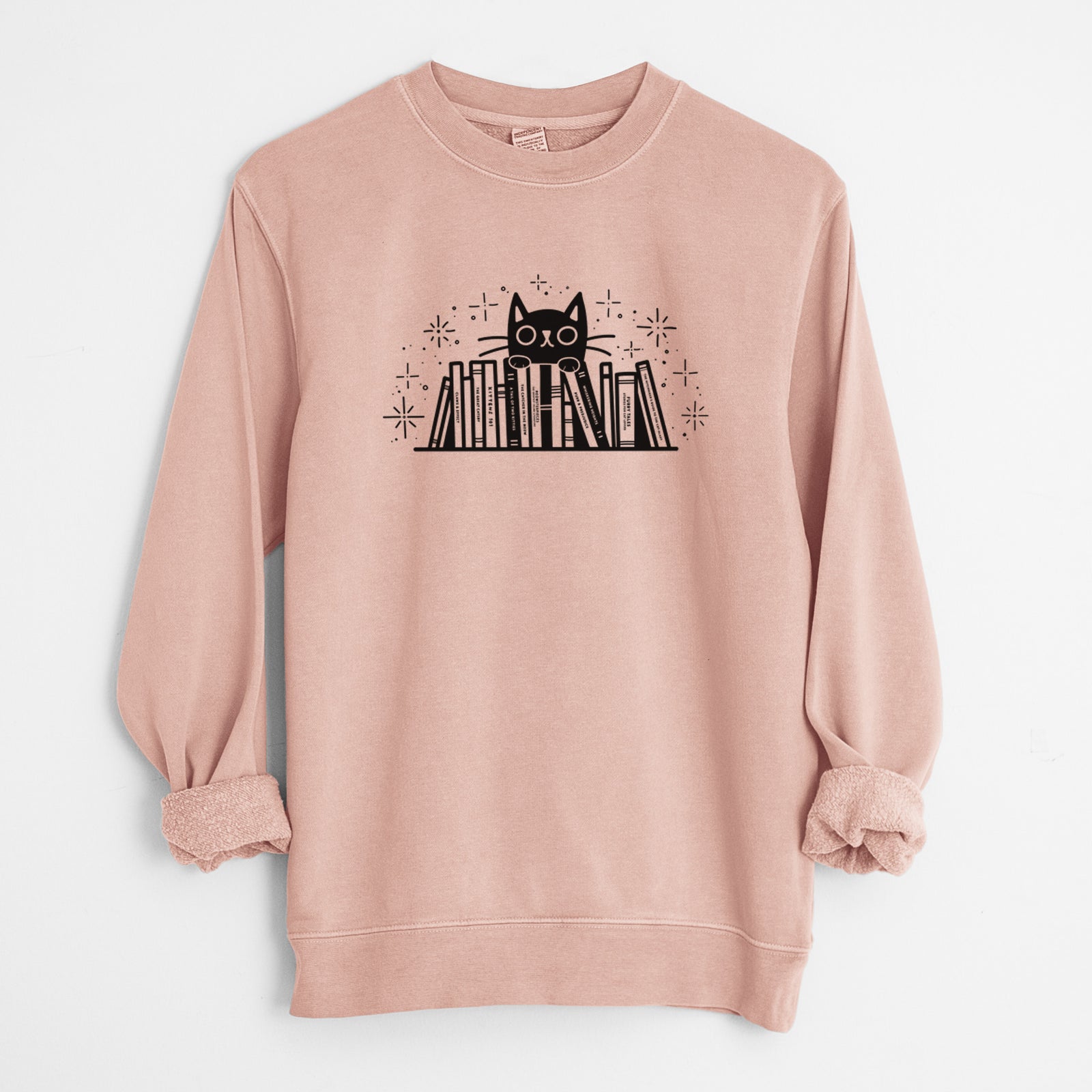 'Kitty Library - Black Cat Behind Books' design on a Dusty Pink Unisex pigment dyed crew sweatshirt