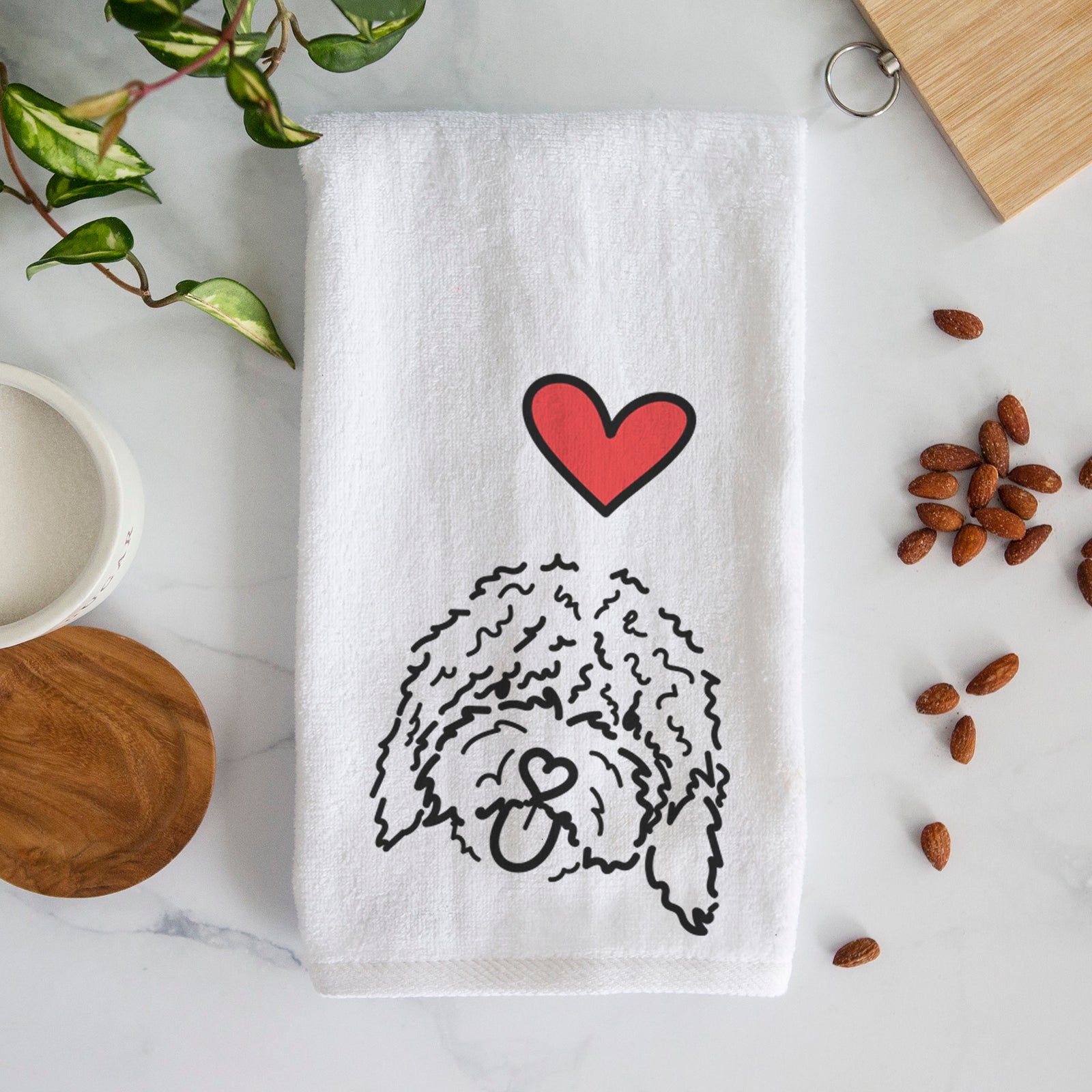 Minimalist line drawing of Antonio the Spanish Water Dog with a red heart on a decorative hand towel