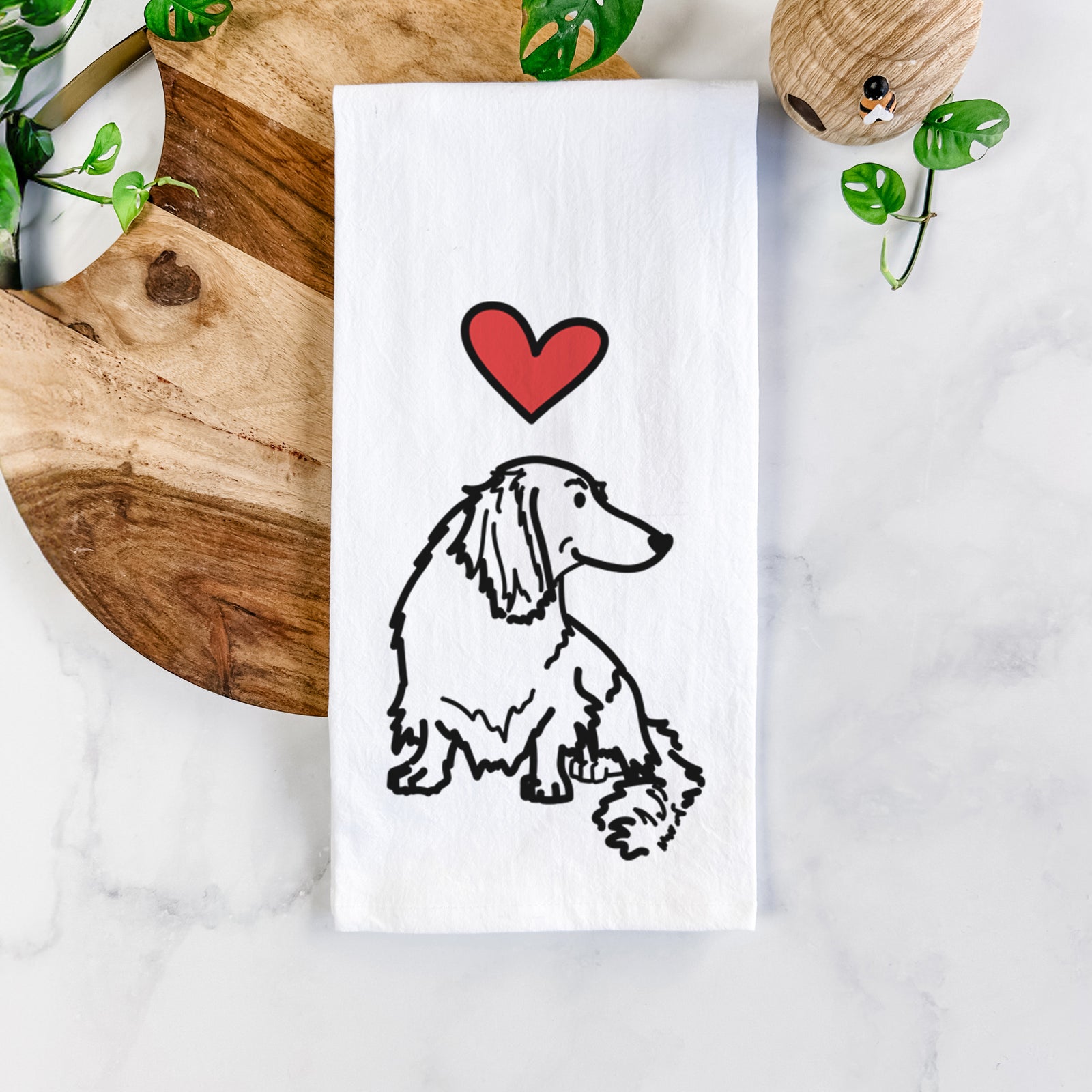Minimalist line drawing of Bella the Dachshund with a red heart on a tea towel