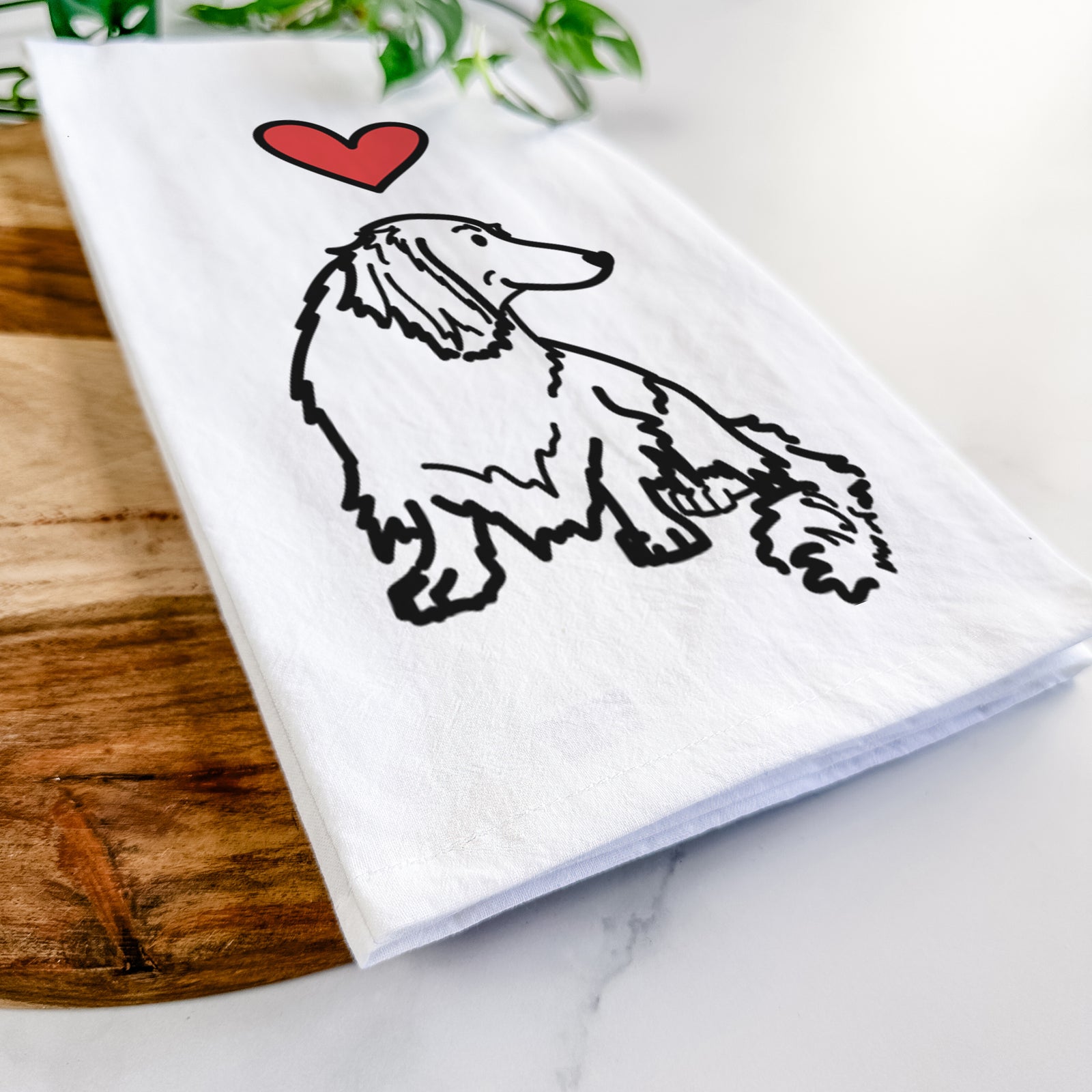 Minimalist line drawing of Bella the Dachshund with a red heart on a tea towel