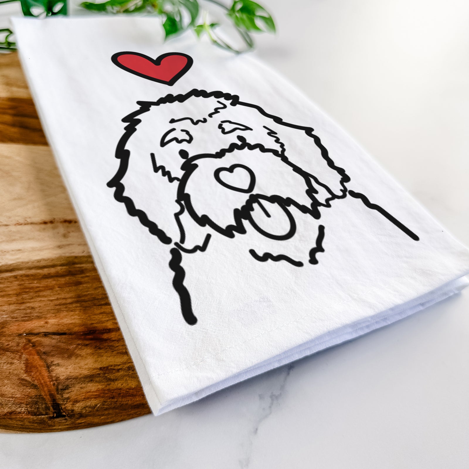 Minimalist line drawing of a Bernedoodle with a red heart on a tea towel