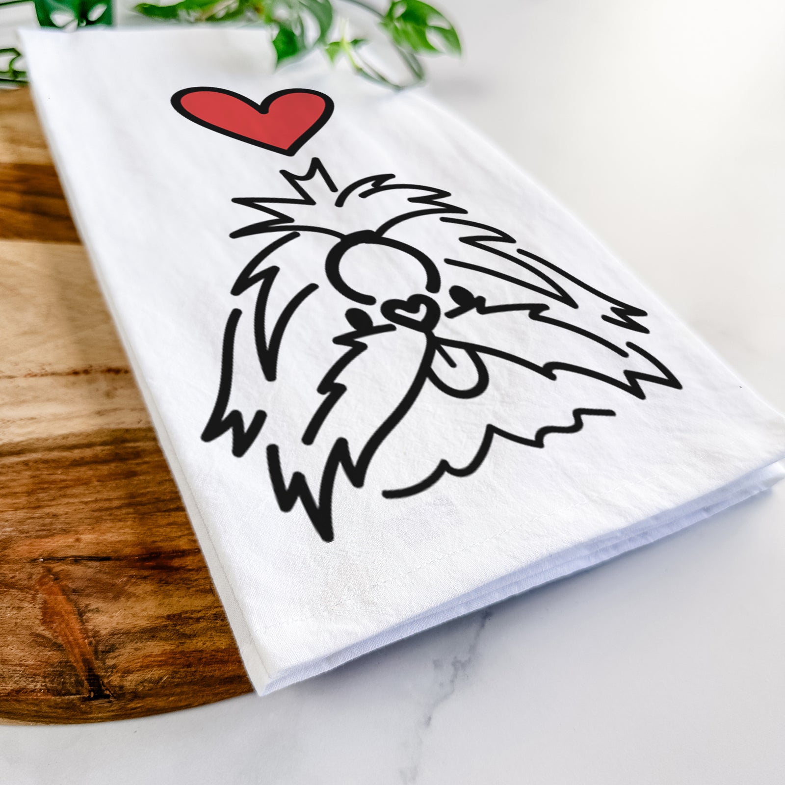Minimalist line drawing of CoCo the Shih Tzu with a red heart on a tea towel