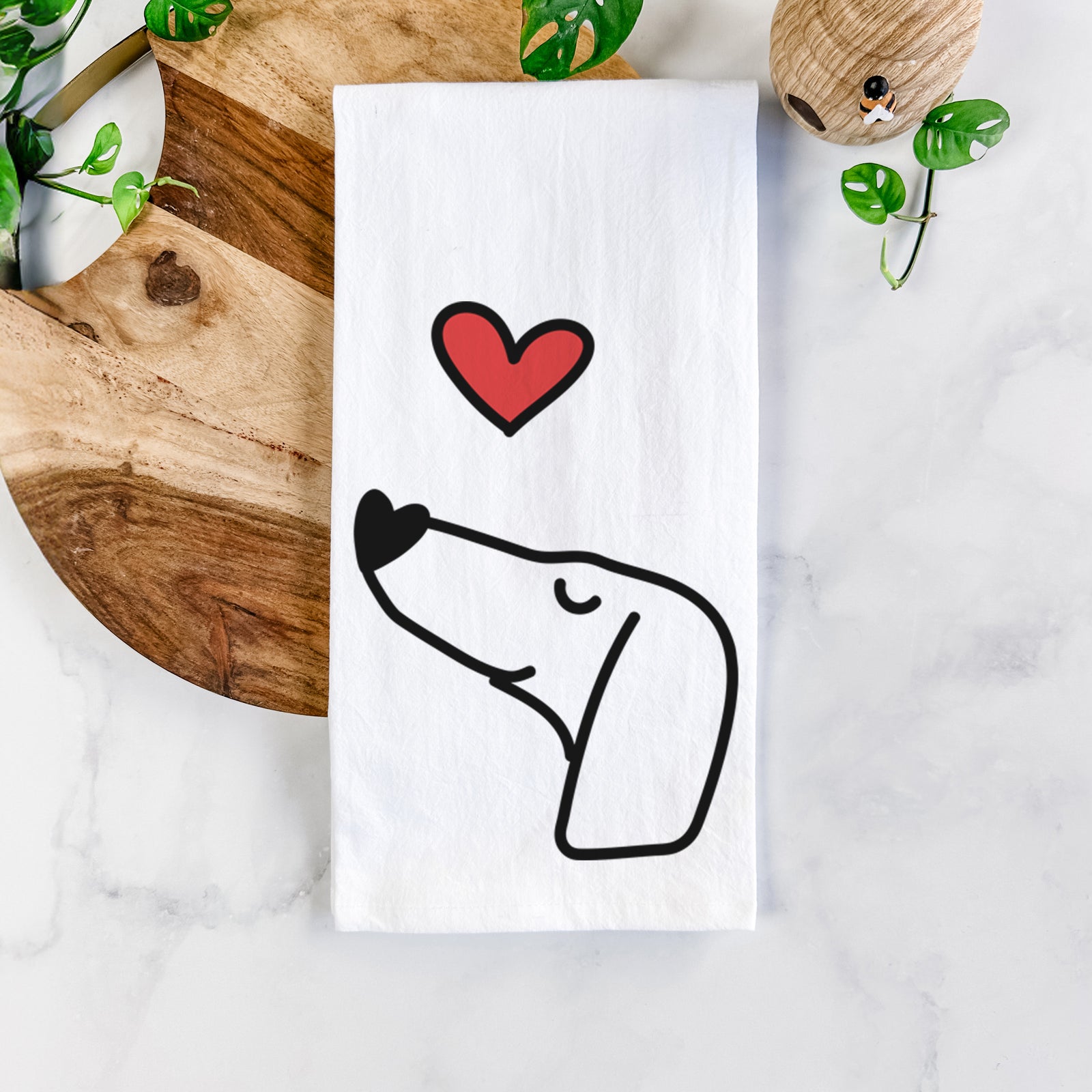 Minimalist line drawing of a Dachshund with a red heart on a tea towel