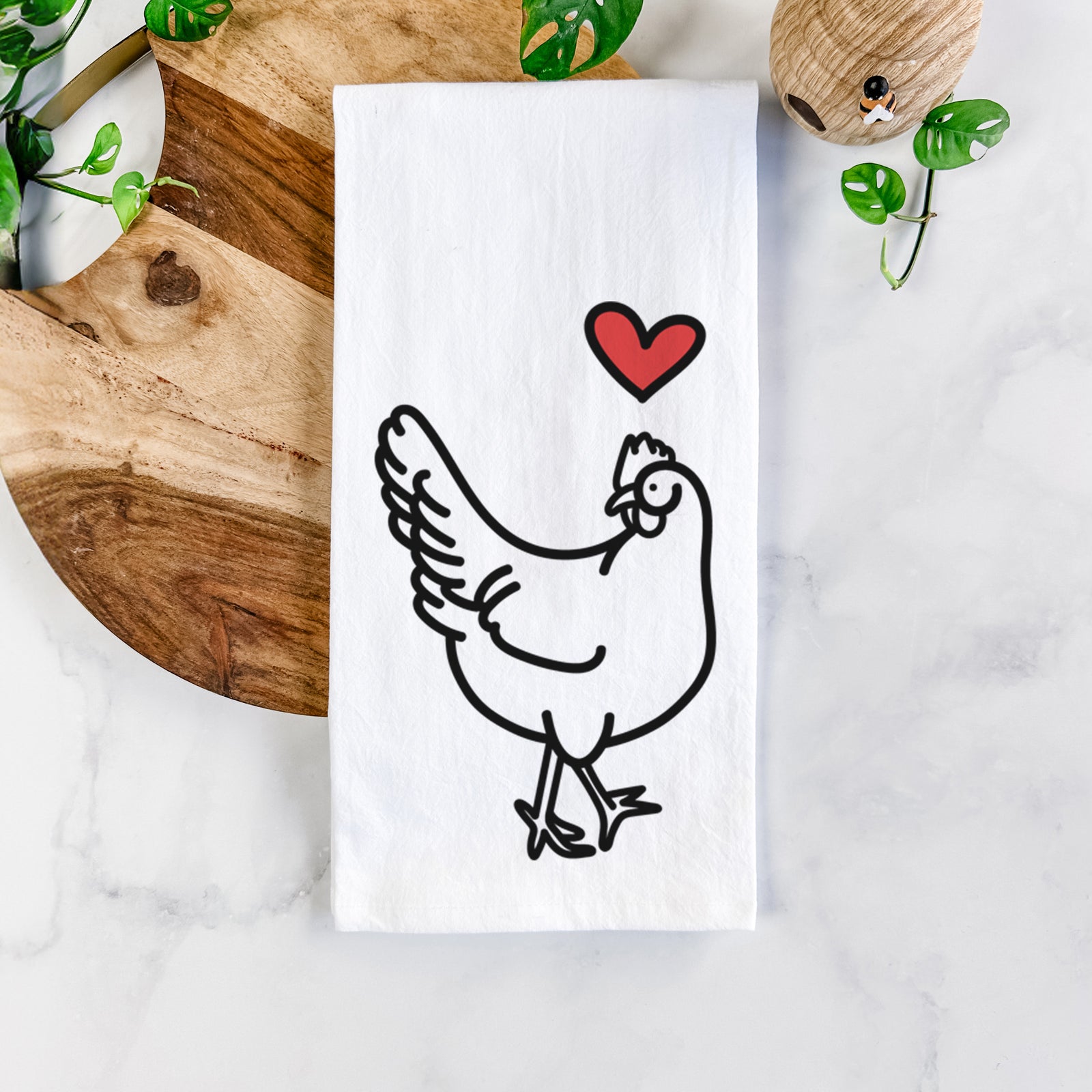 Minimalist line drawing of Daisy the Chicken with a red heart on a tea towel