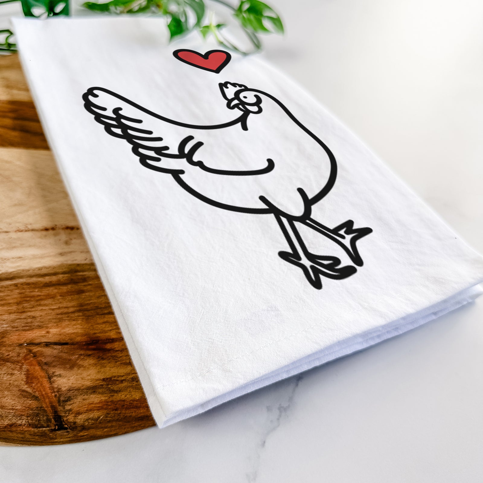 Minimalist line drawing of Daisy the Chicken with a red heart on a tea towel