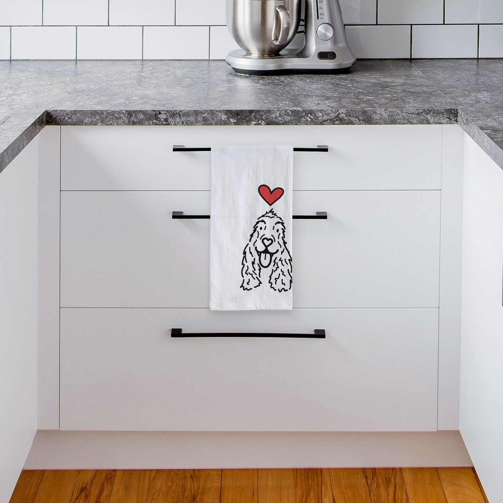 Minimalist line drawing of Dolly the English Cocker Spaniel with a red heart on a tea towel, hanging on an oven door in a kitchen