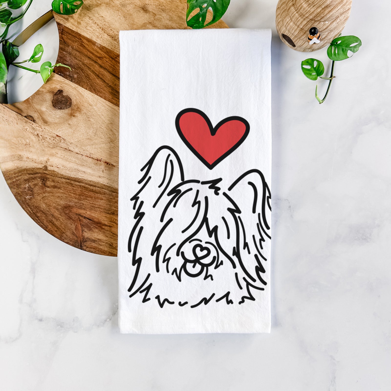 Minimalist line drawing of Dougal the Skye Terrier with a red heart on a tea towel