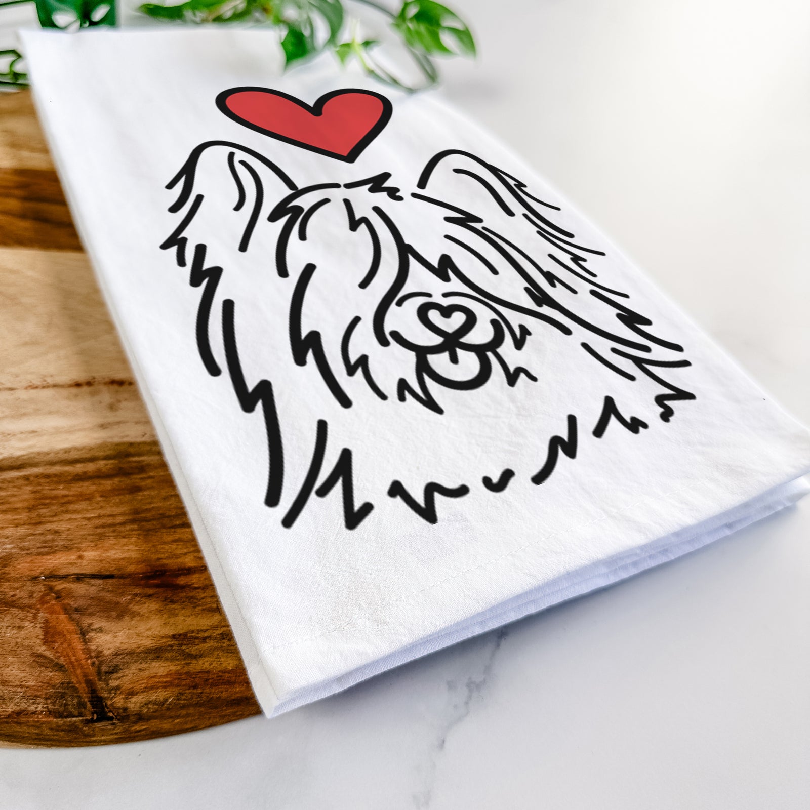 Minimalist line drawing of Dougal the Skye Terrier with a red heart on a tea towel
