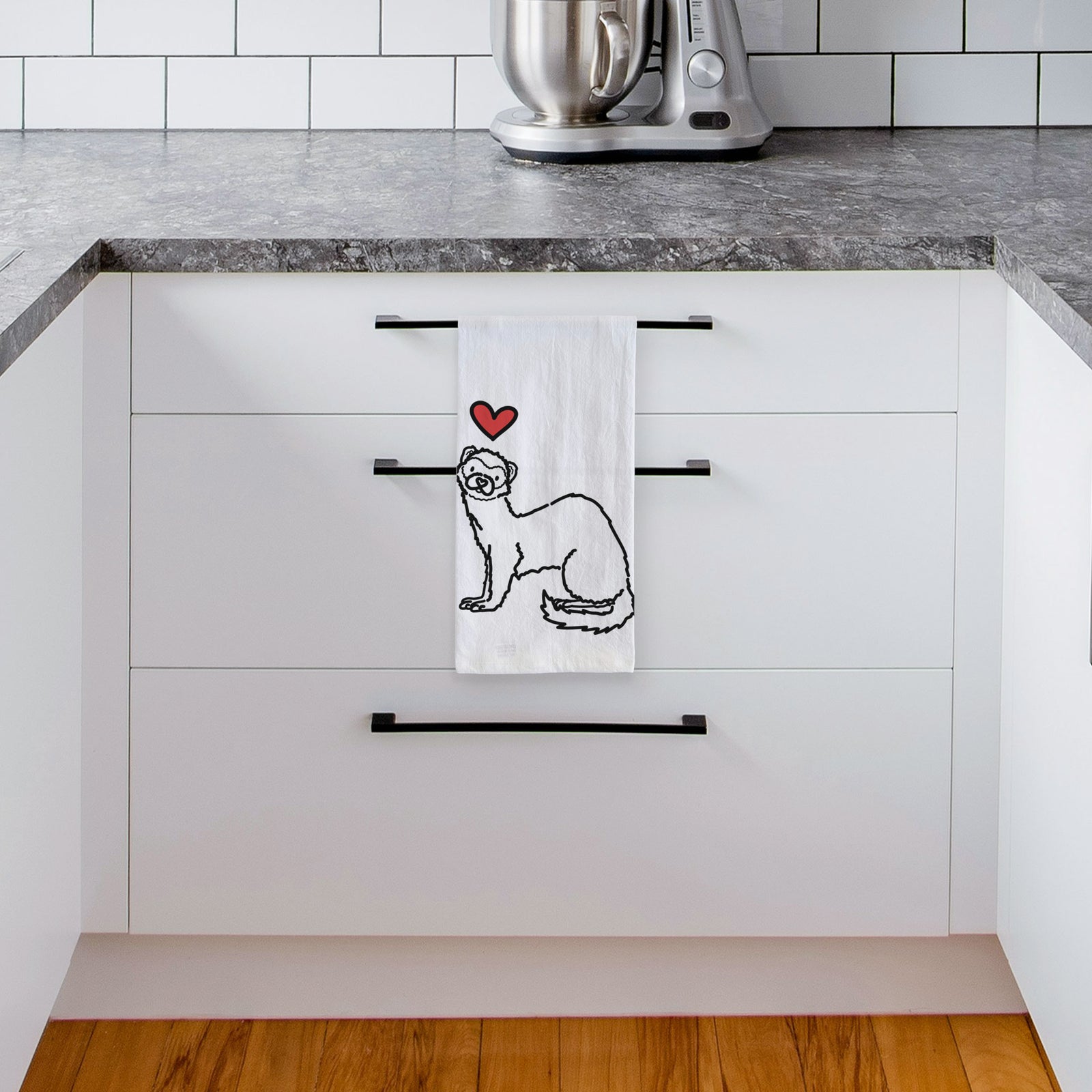 Minimalist line drawing of Fern the Ferret with a red heart on a tea towel, hanging on an oven door in a kitchen