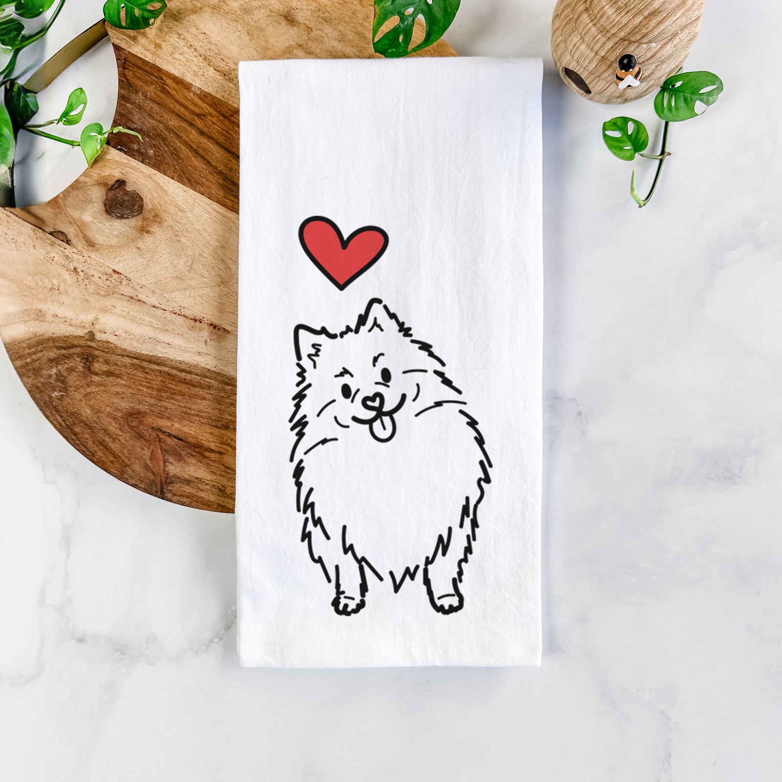Minimalist line drawing of Fern the Pomeranian with a red heart on a tea towel