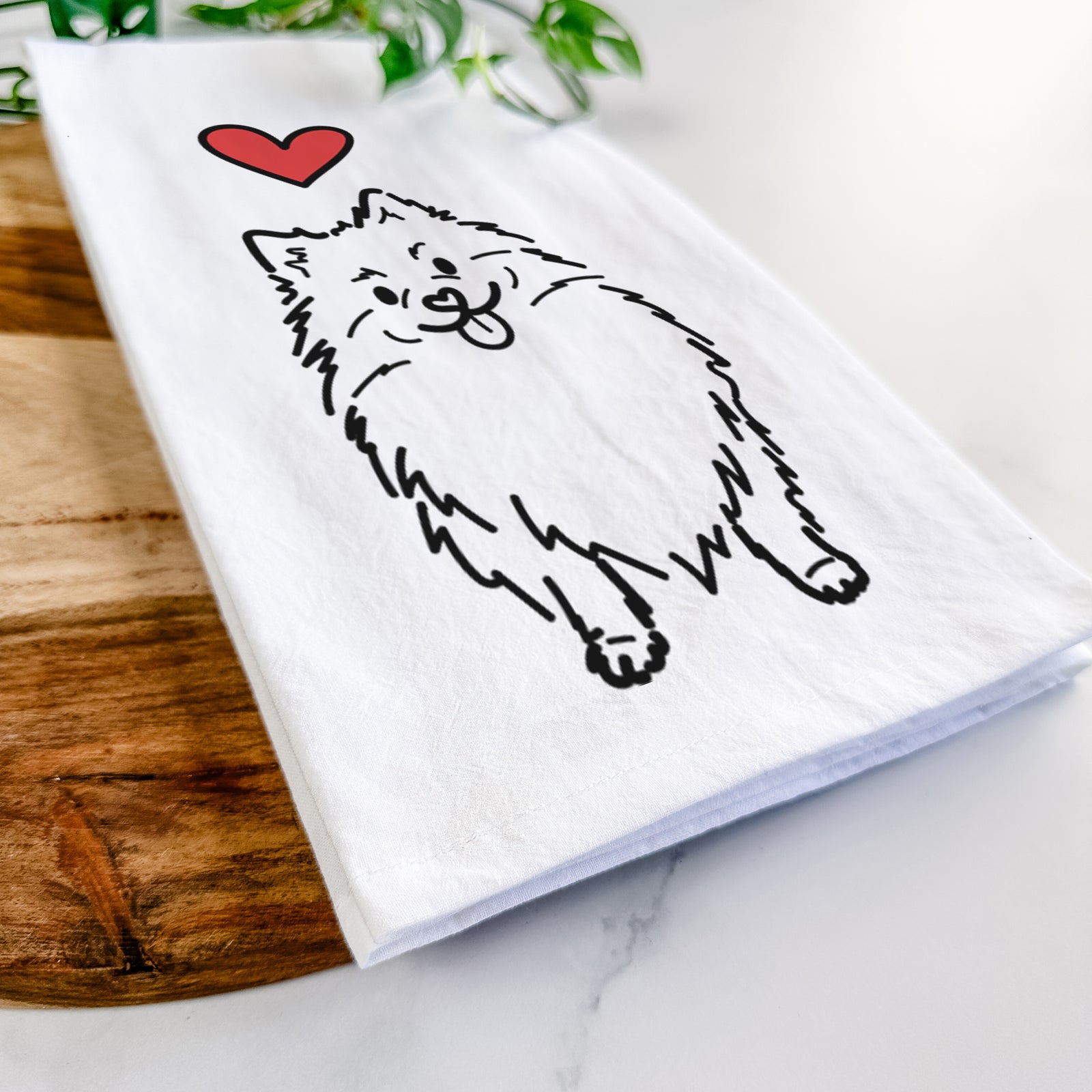 Minimalist line drawing of Fern the Pomeranian with a red heart on a tea towel