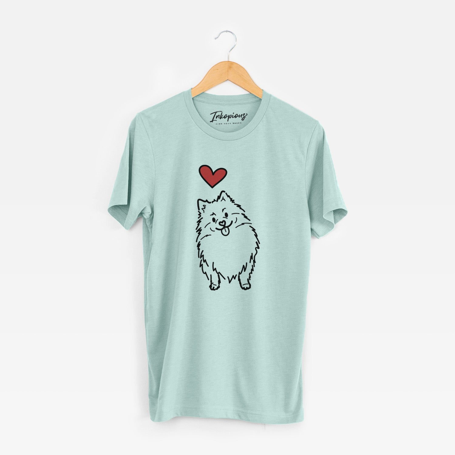 Minimalist line drawing of Fern the Pomeranian with a red heart on a Heather Sage Unisex crewneck