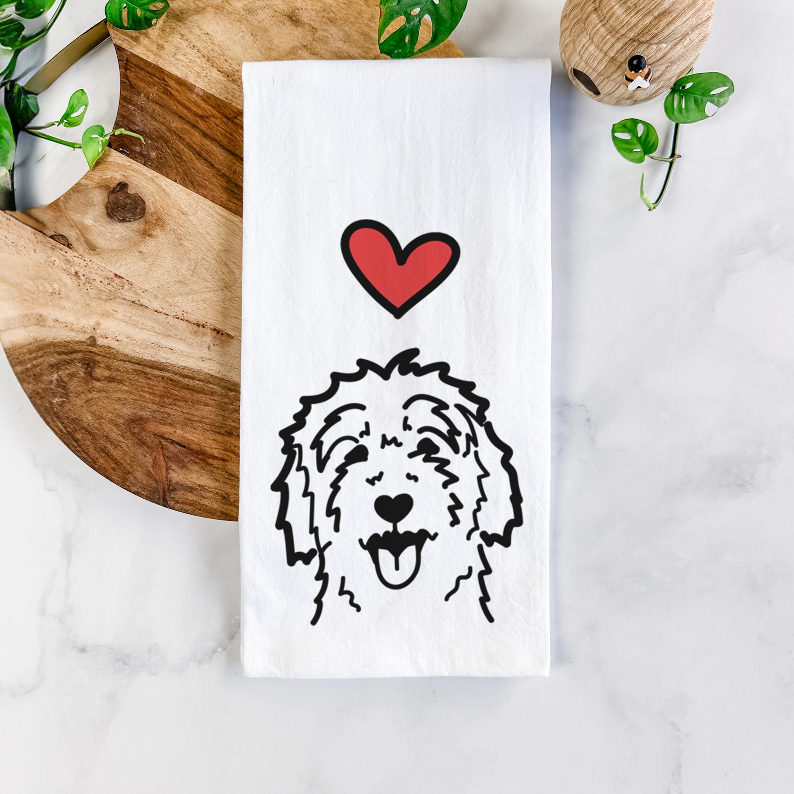 Minimalist line drawing of a Goldendoodle with a red heart on a tea towel