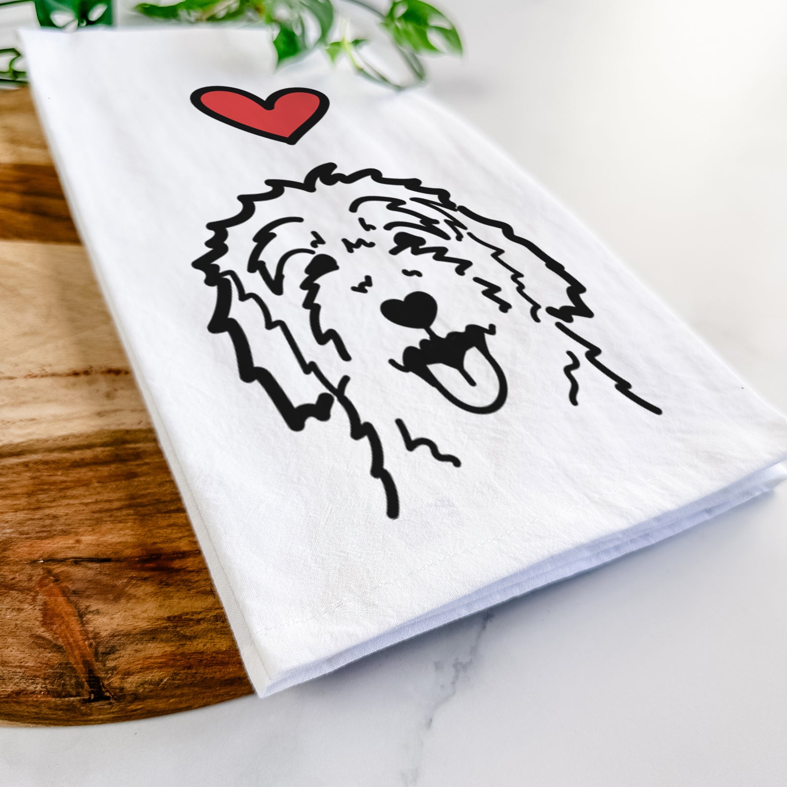 Minimalist line drawing of a Goldendoodle with a red heart on a tea towel