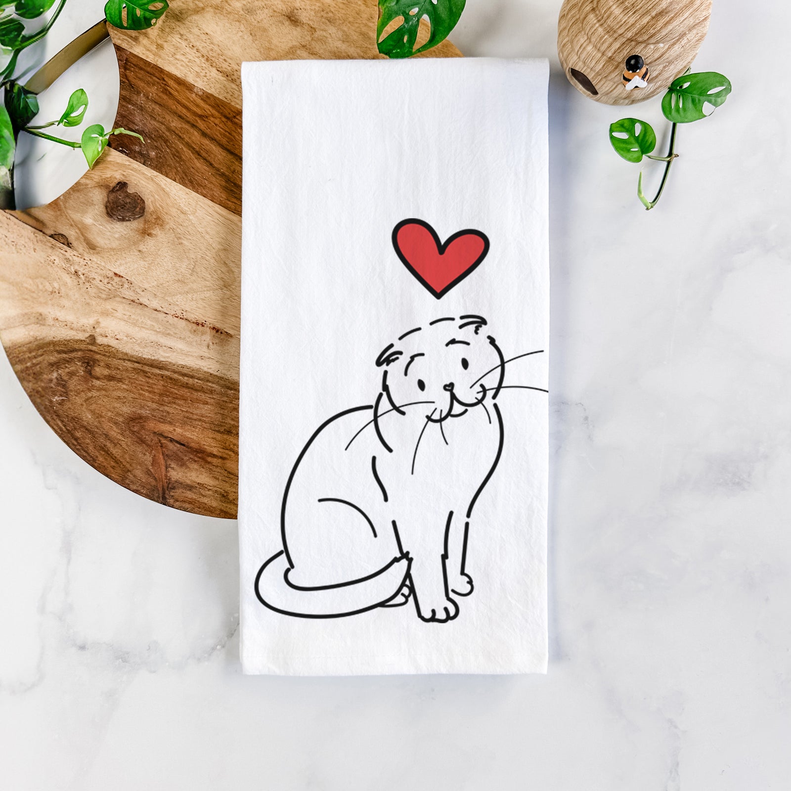 Minimalist line drawing of Hank the Scottish Fold Cat with a red heart on a tea towel