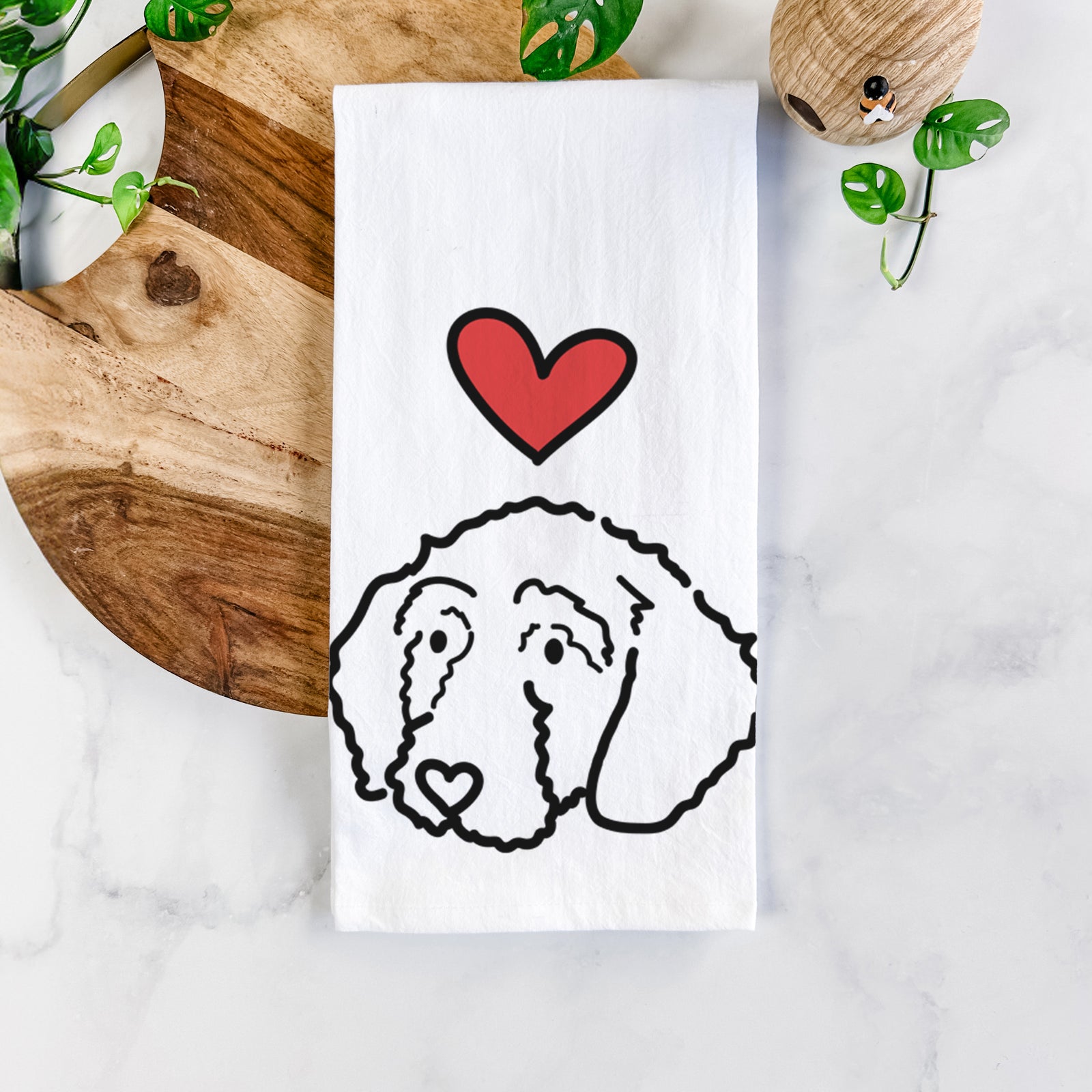 Minimalist line drawing of Hanna the Goldendoodle with a red heart on a tea towel