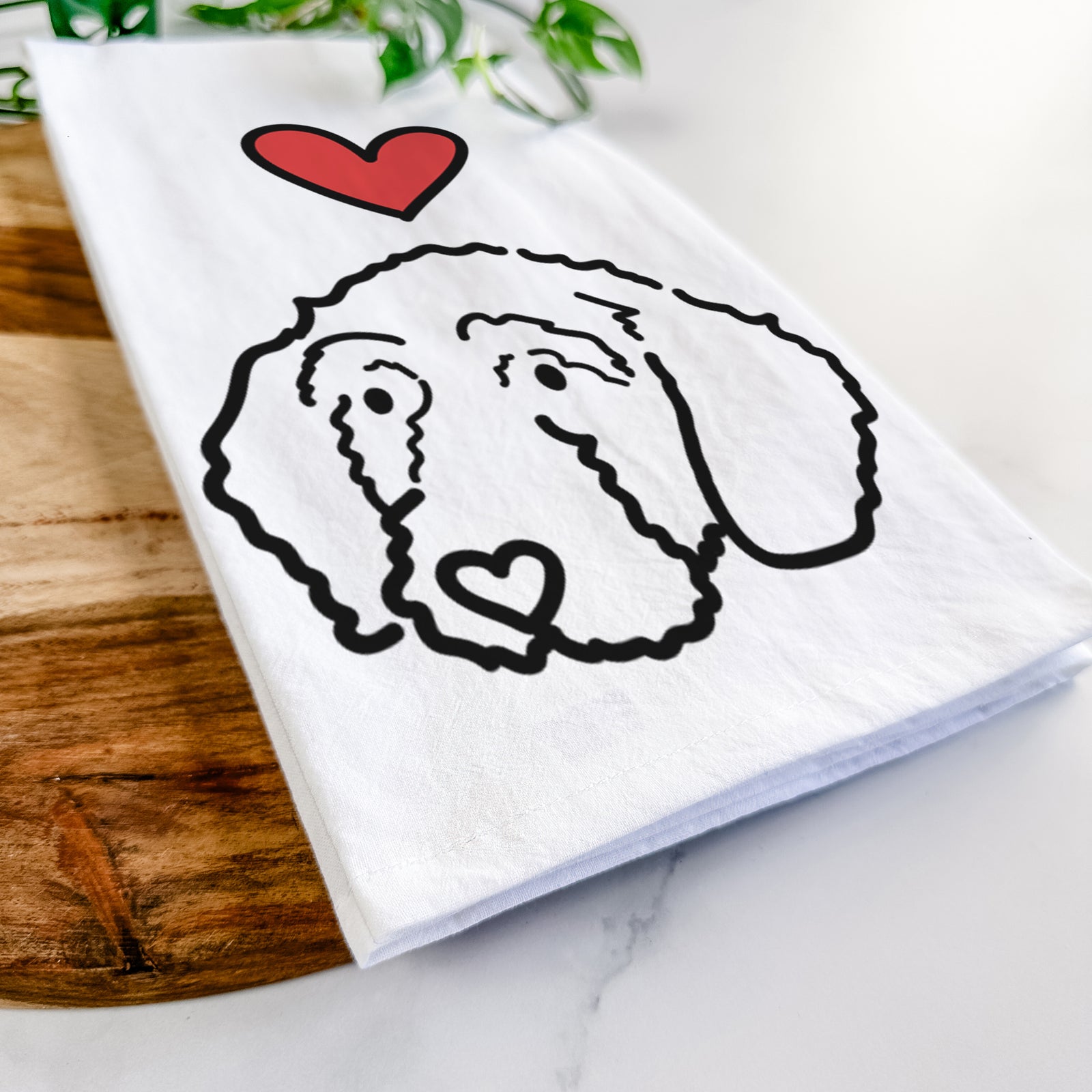 Minimalist line drawing of Hanna the Goldendoodle with a red heart on a tea towel