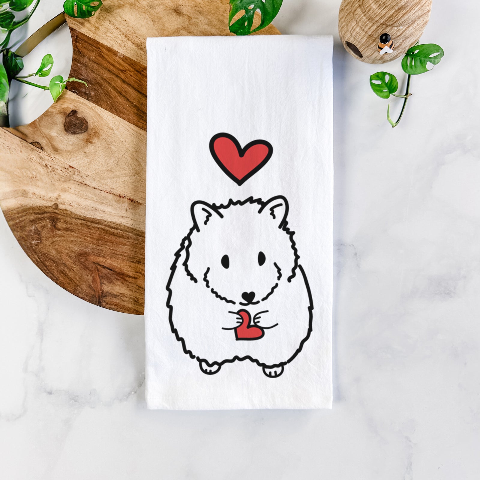 Minimalist line drawing of Hilga the Hamster with a red heart on a tea towel