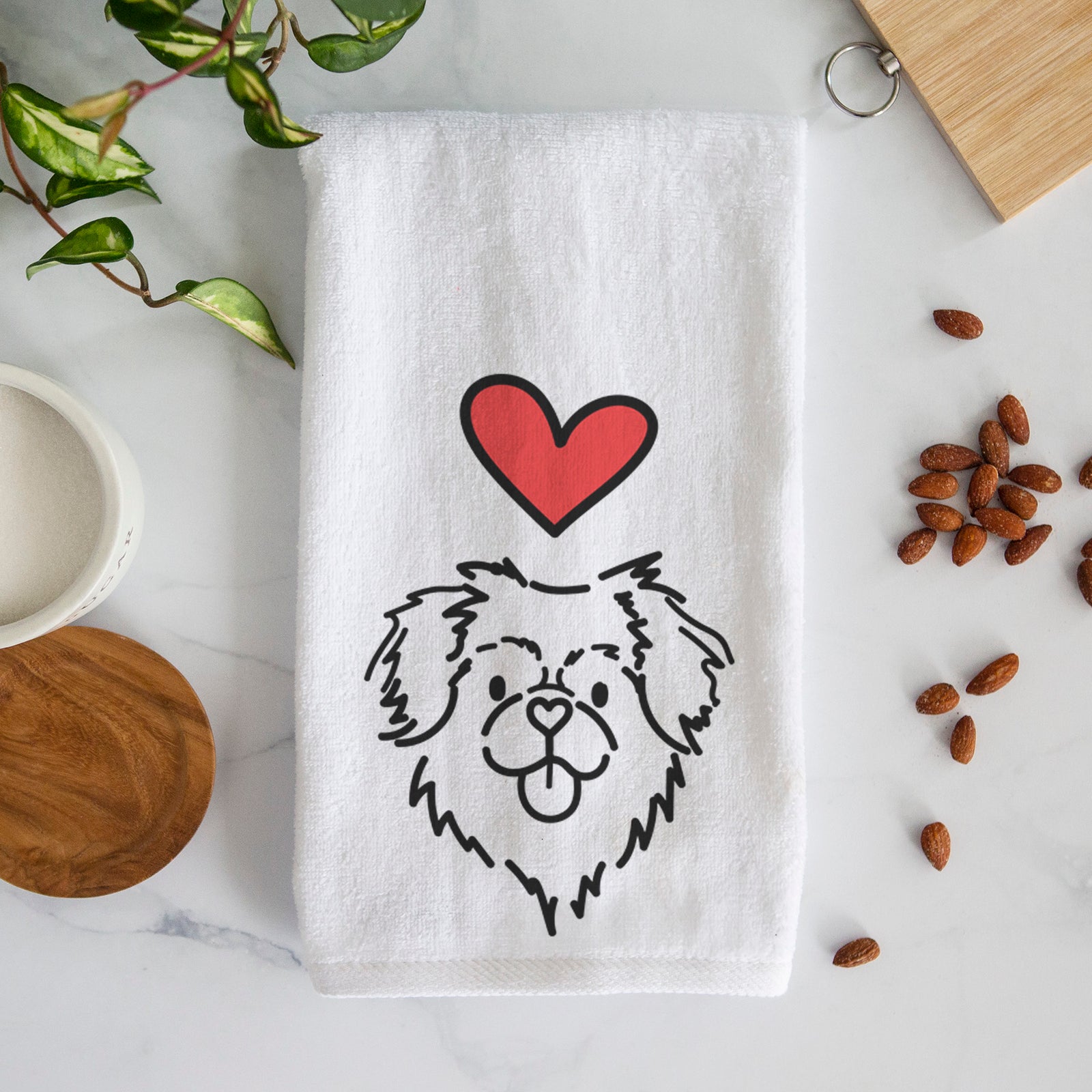 Minimalist line drawing of Jiji the Tibetan Spaniel with a red heart on a decorative hand towel