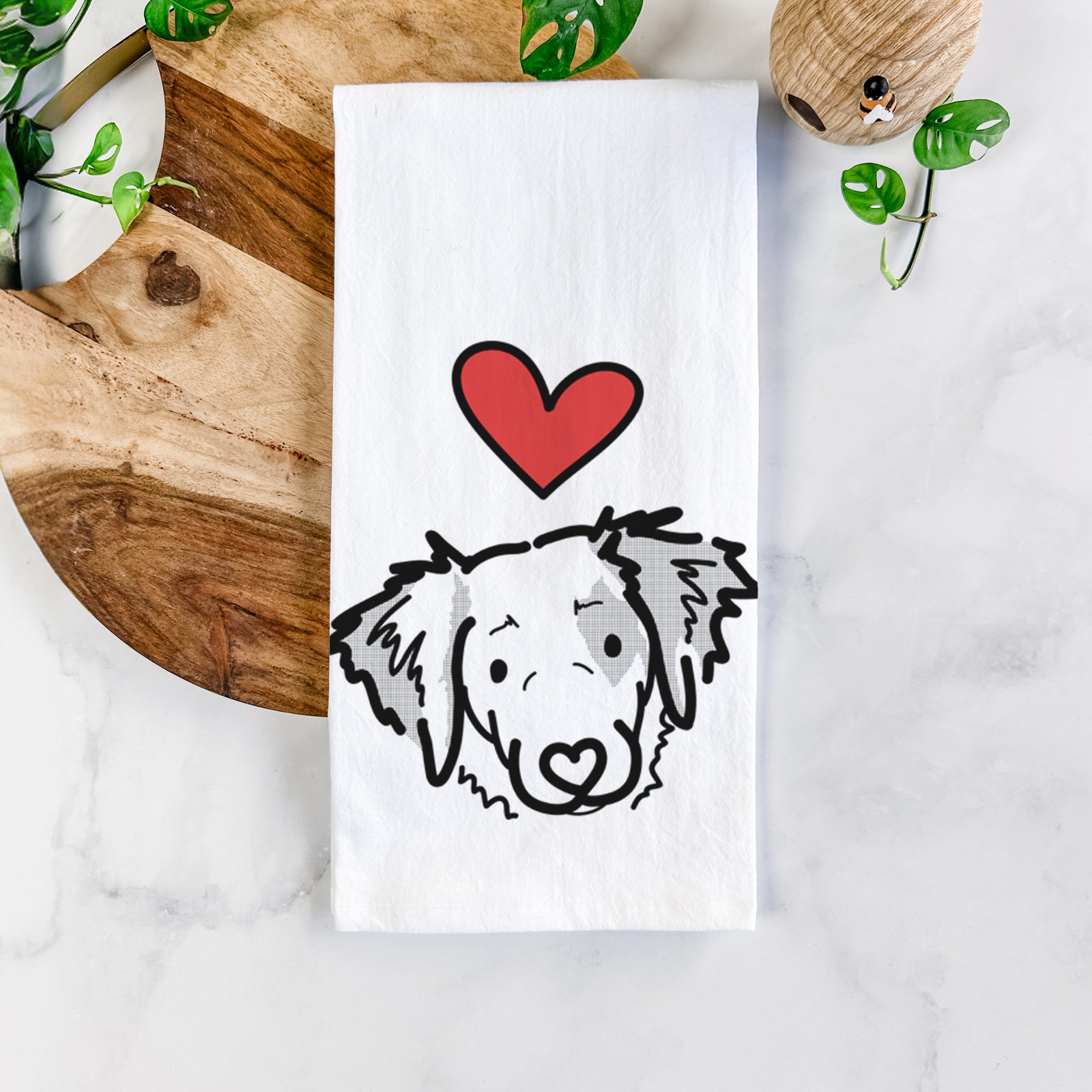 Minimalist line drawing of Kiva the Brittany Spaniel with a red heart on a tea towel