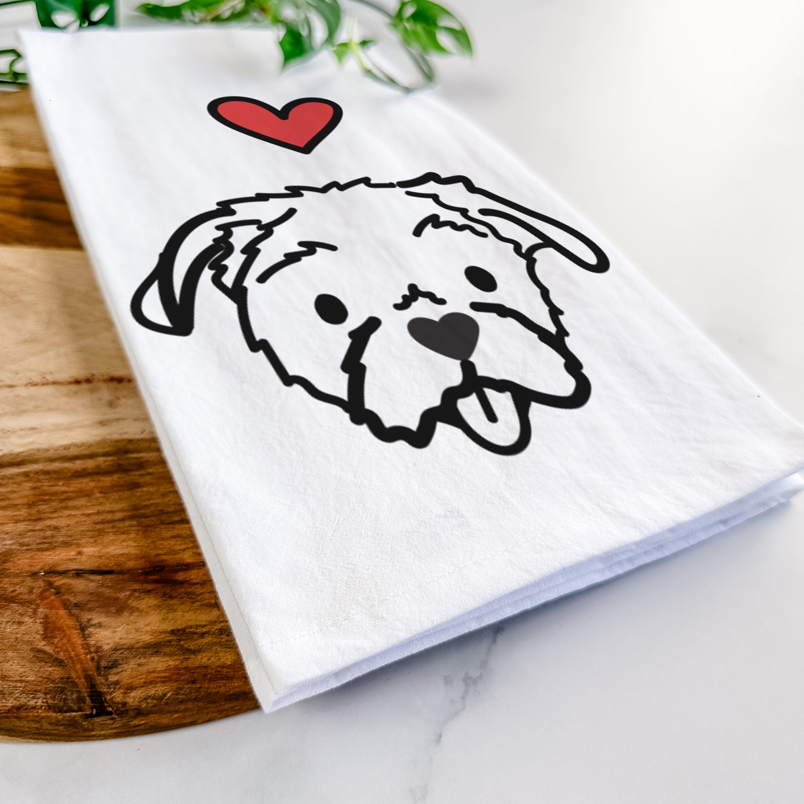 Minimalist line drawing of Koko the Shih Tzu with a red heart on a tea towel