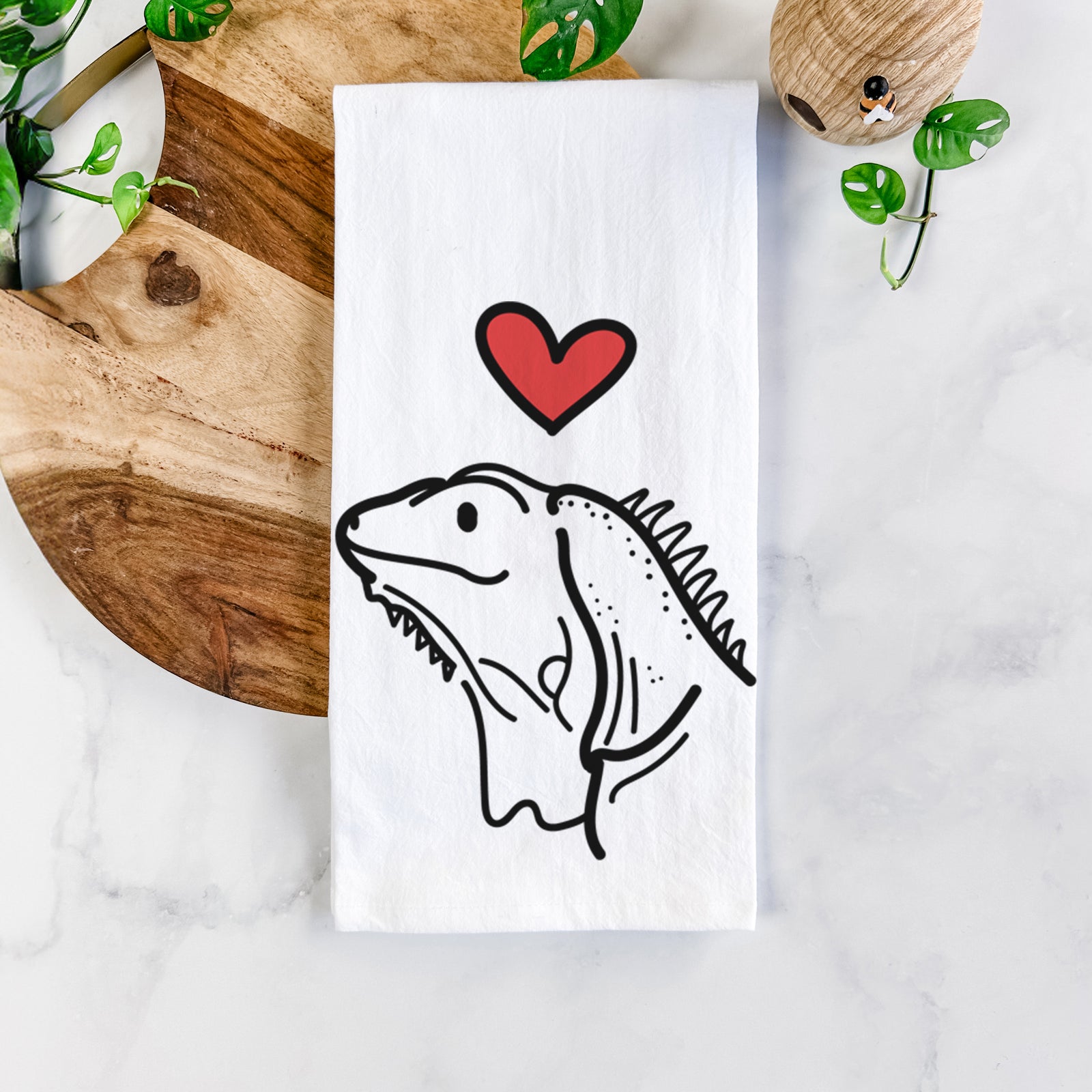 Minimalist line drawing of Louie the Iguana with a red heart on a tea towel