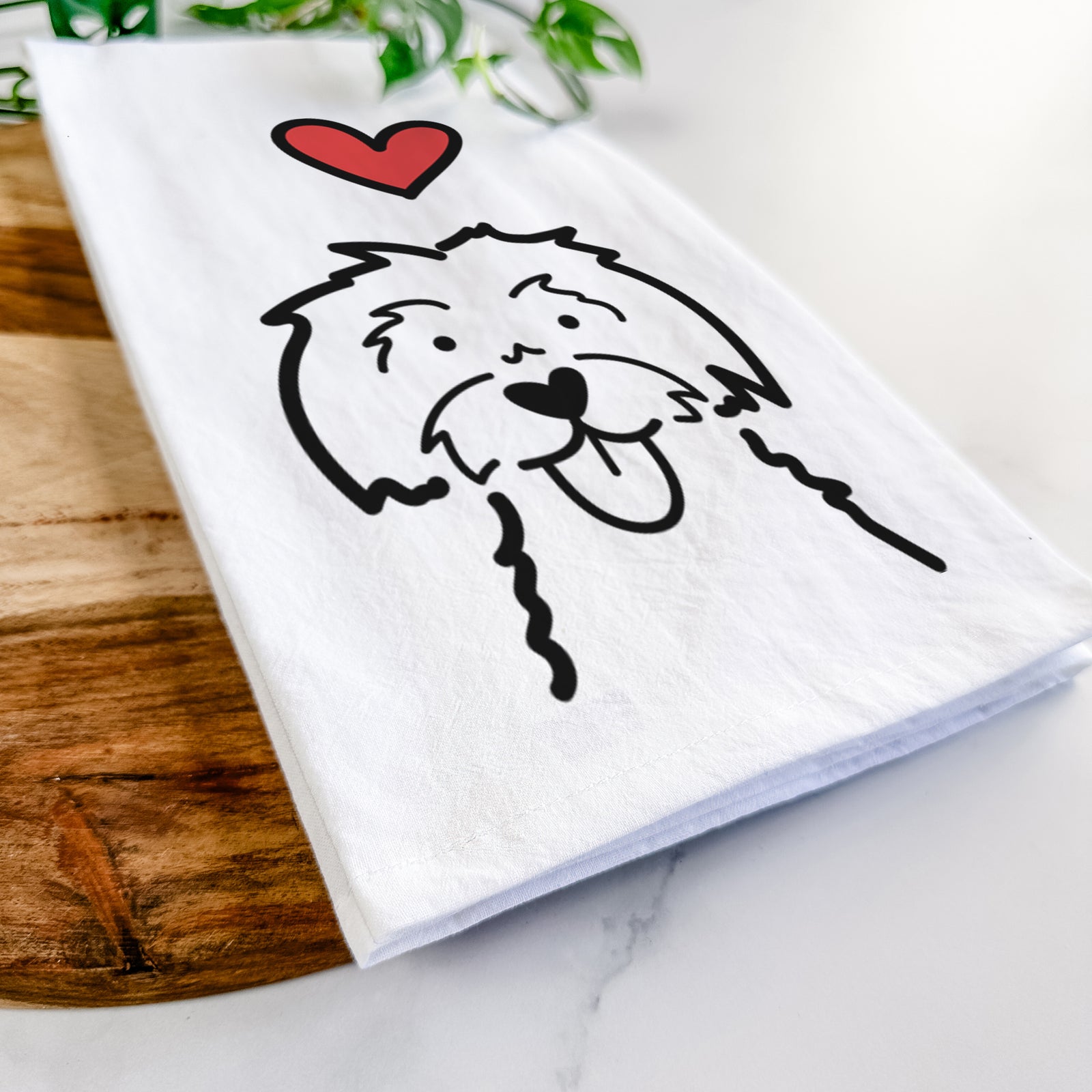 Minimalist line drawing of a Maltese with a red heart on a tea towel