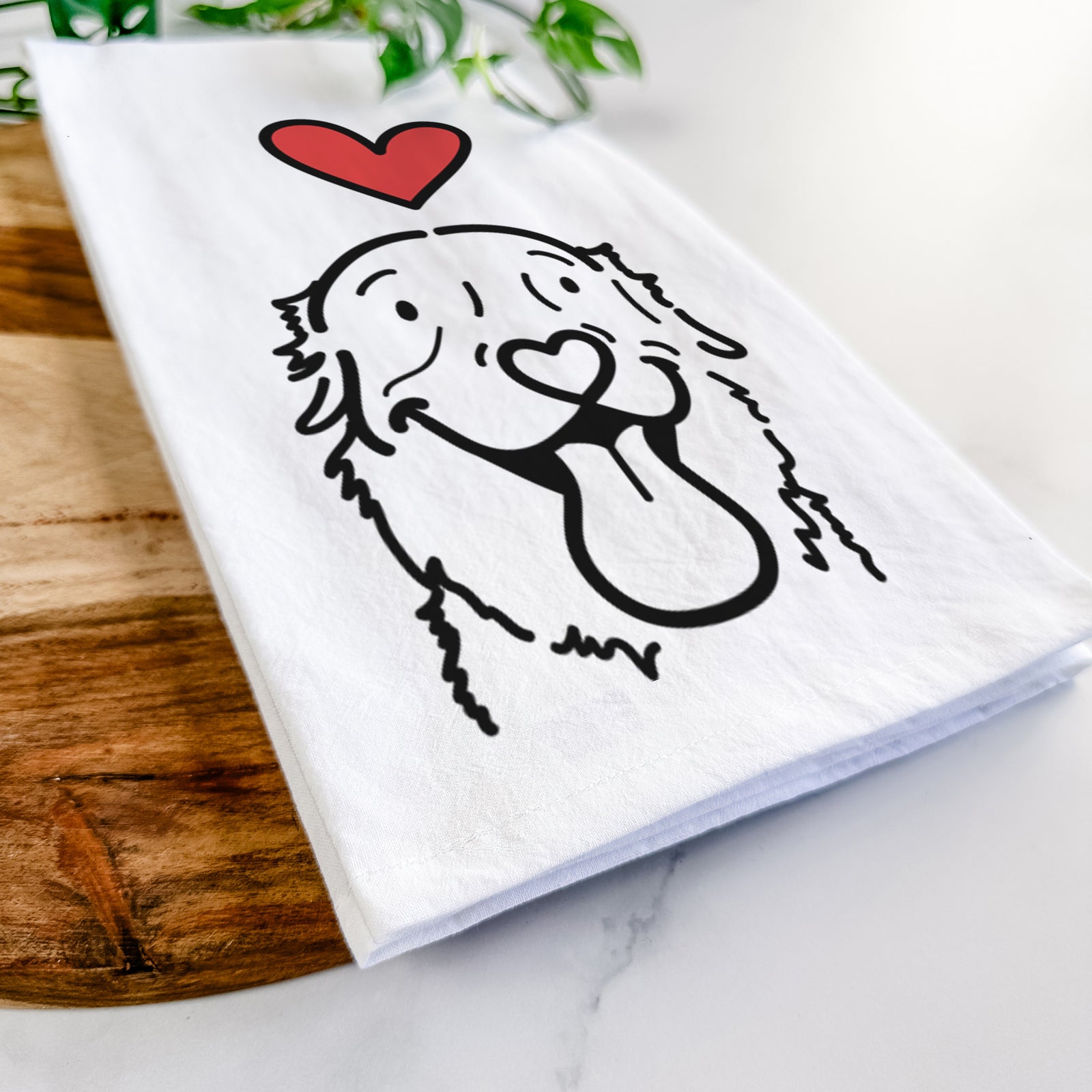 Minimalist line drawing of Maple the Golden Retriever with a red heart on a tea towel