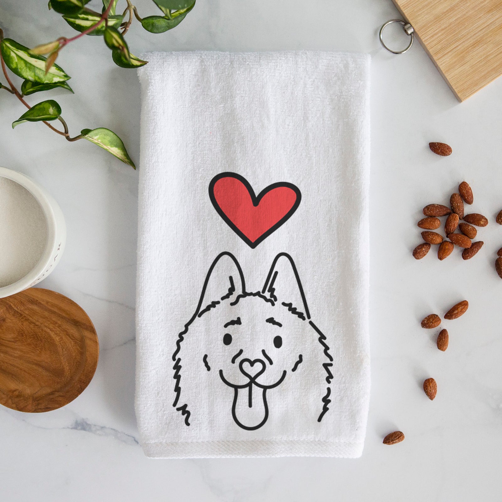 Minimalist line drawing of Meeko the Schipperke with a red heart on a decorative hand towel