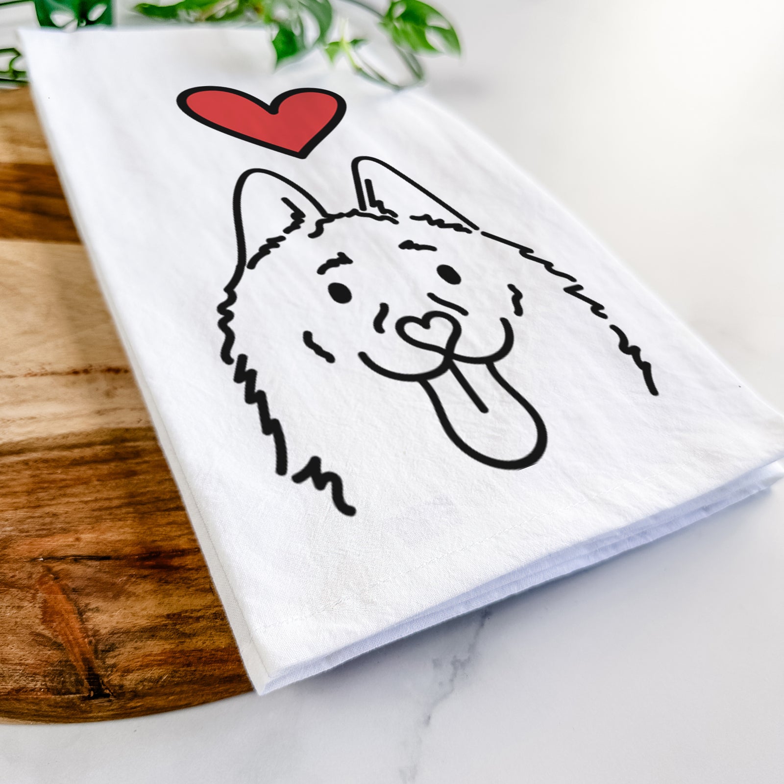 Minimalist line drawing of Meeko the Schipperke with a red heart on a tea towel