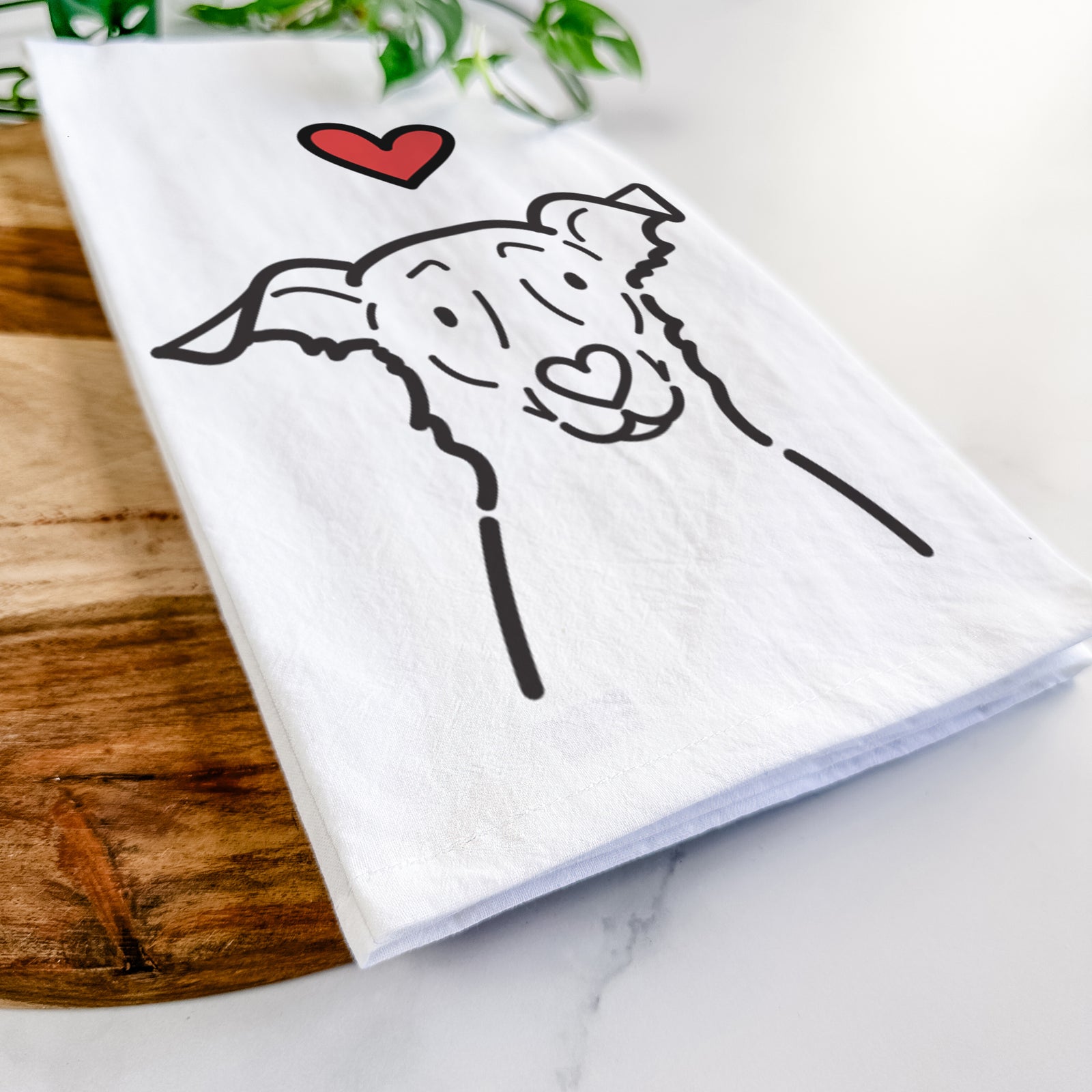 Minimalist line drawing of Millie the Border Collie Mix with a red heart on a tea towel