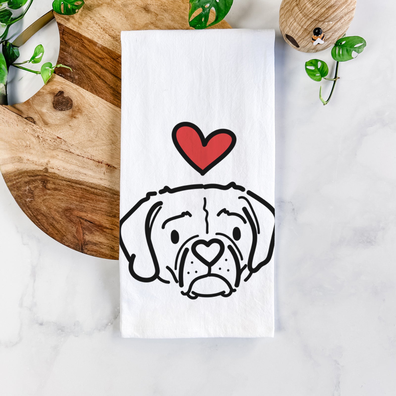 Minimalist line drawing of Mitzi the Puggle with a red heart on a tea towel