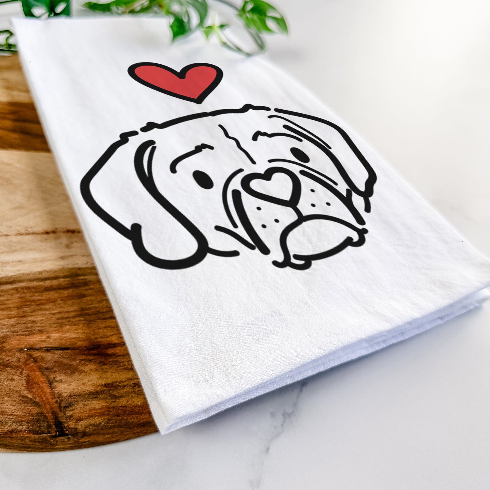 Minimalist line drawing of Mitzi the Puggle with a red heart on a tea towel