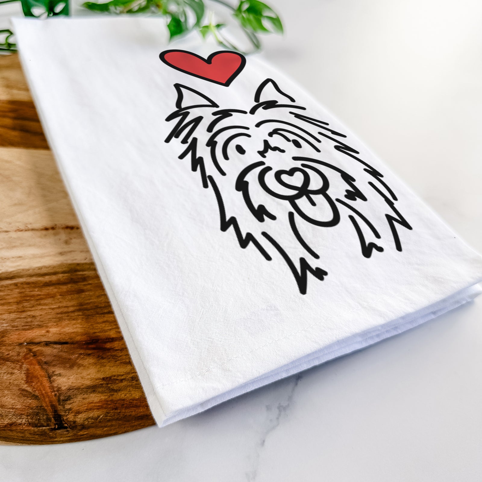 Minimalist line drawing of Monty the Silky Terrier with a red heart on a tea towel