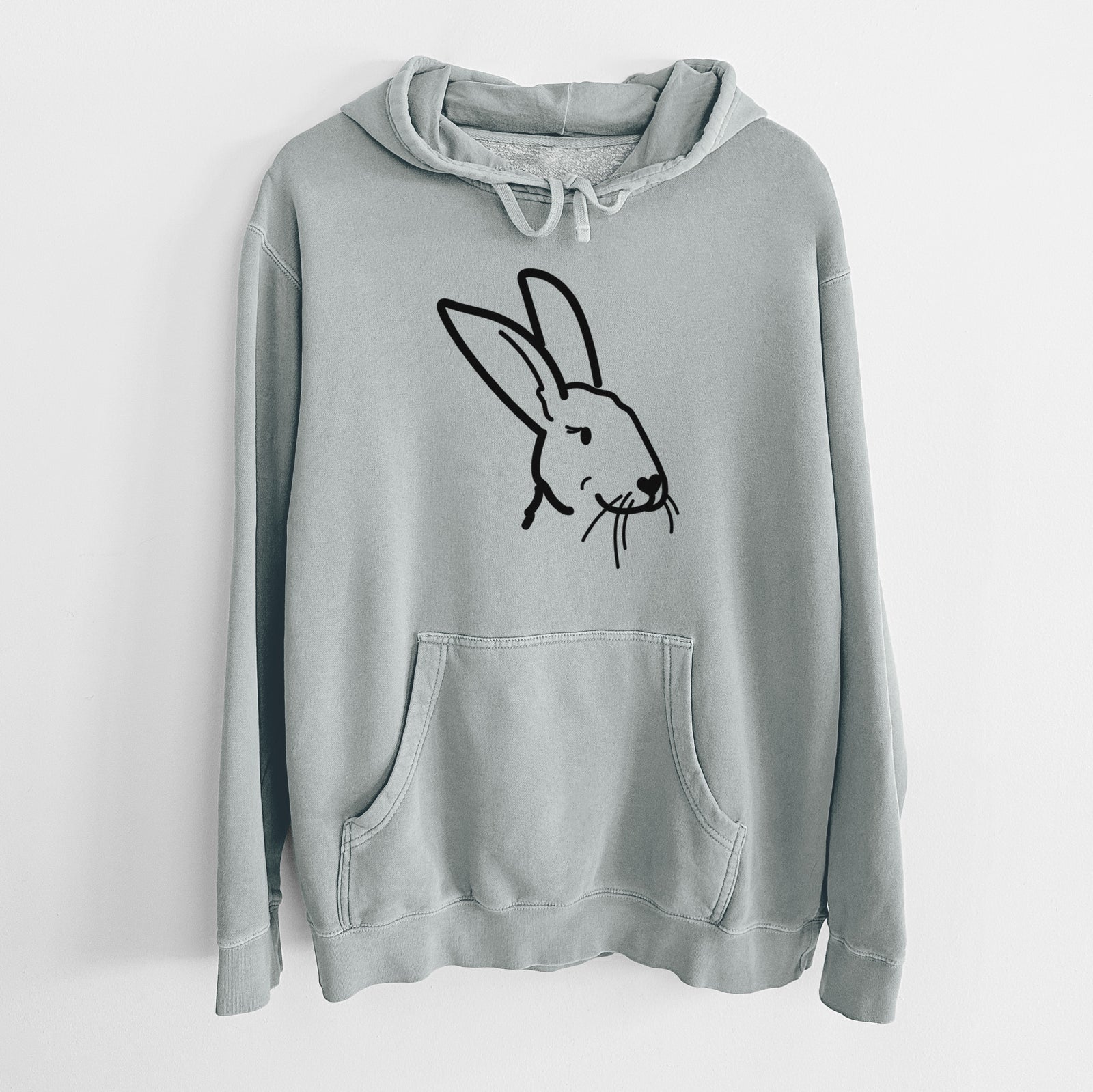 Minimalist line drawing of Betsy the Rex Rabbit on a Sage Unisex pigment dyed hoodie