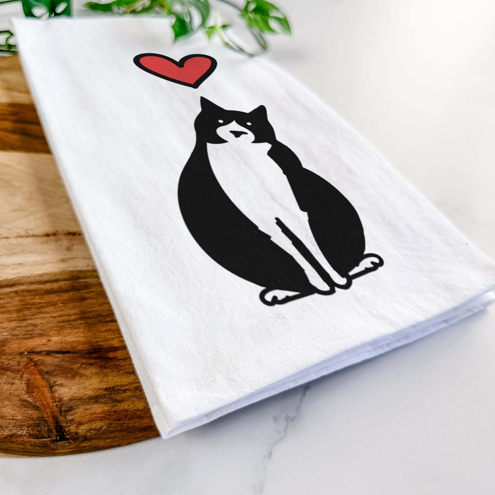 Minimalist line drawing of Oliver the Tuxedo Cat with a red heart on a tea towel